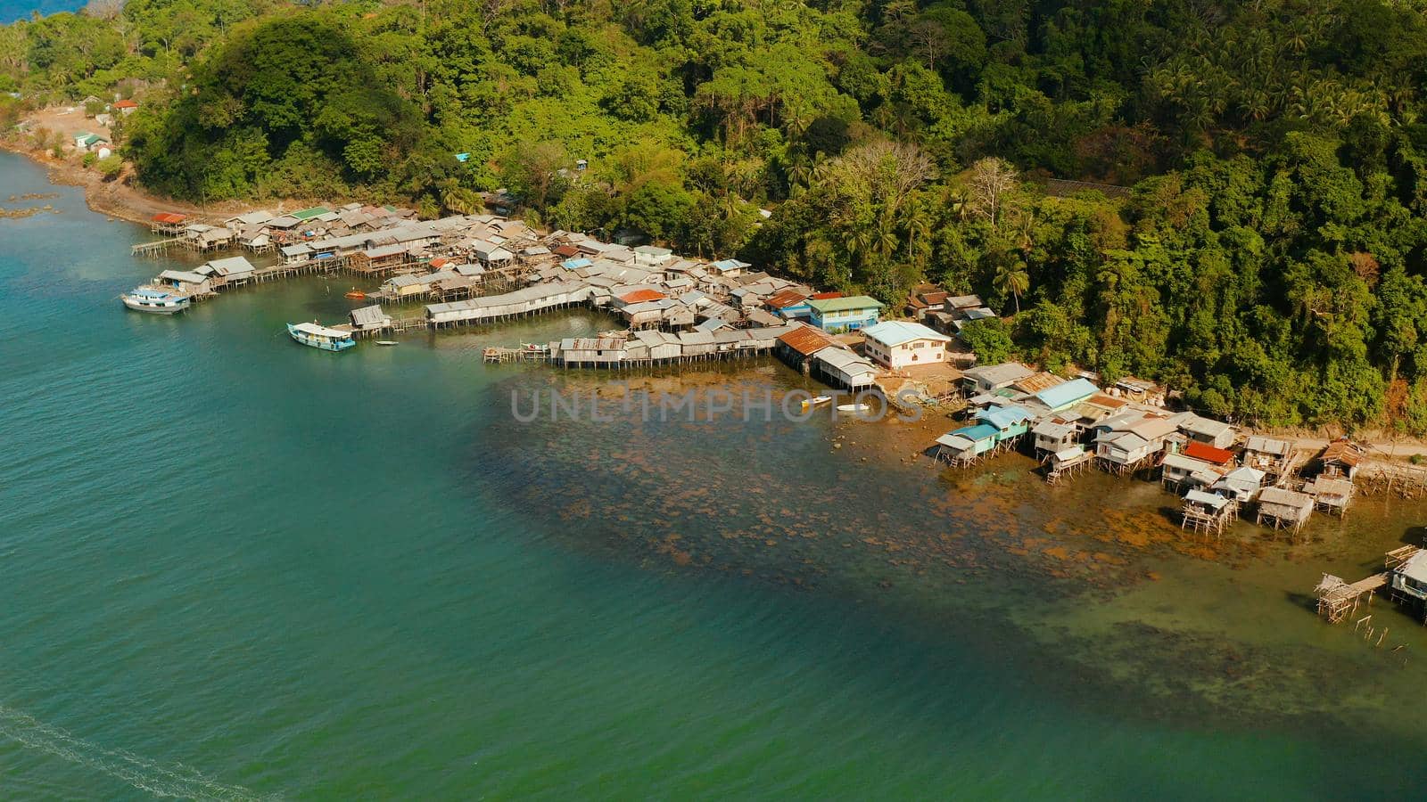Old wooden house standing on the sea in the fishing village. City port on Balabac island, Palawan, Philippines.