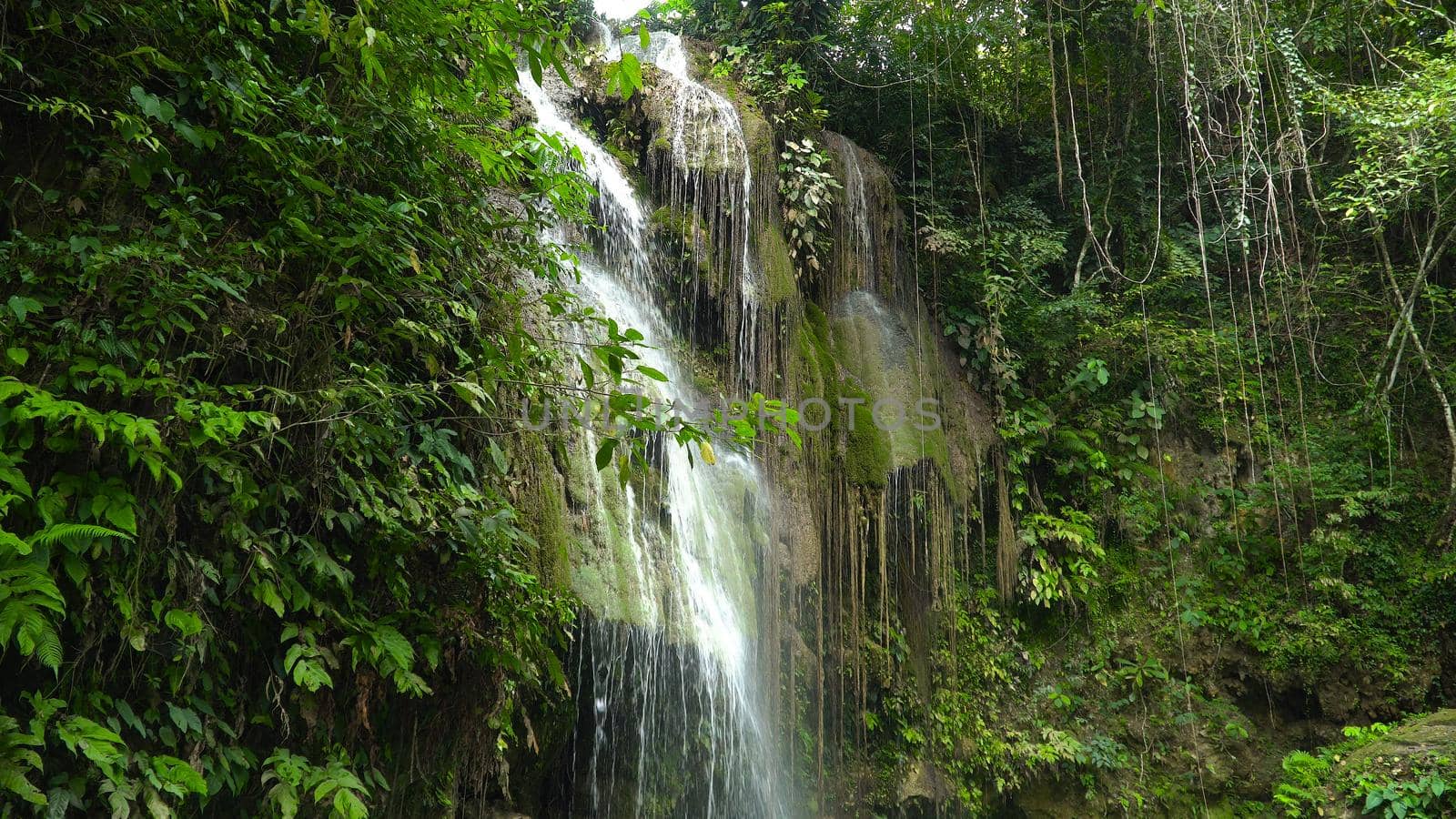 Cambais waterfalls in a mountain gorge in the tropical jungle, Philippines, Cebu. Waterfall in the tropical forest.