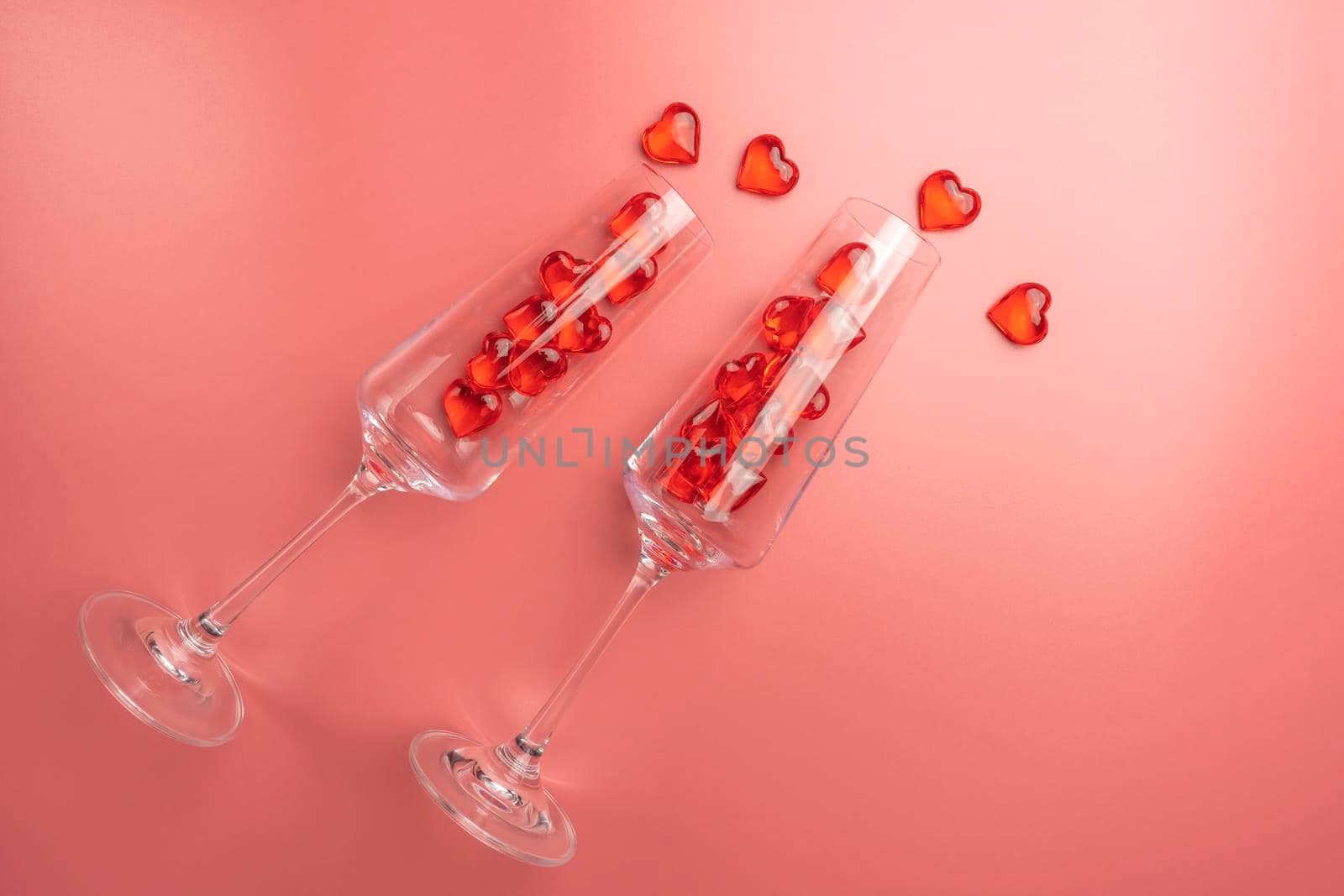 two glasses with hearts on a red background. the view from the top. High quality photo