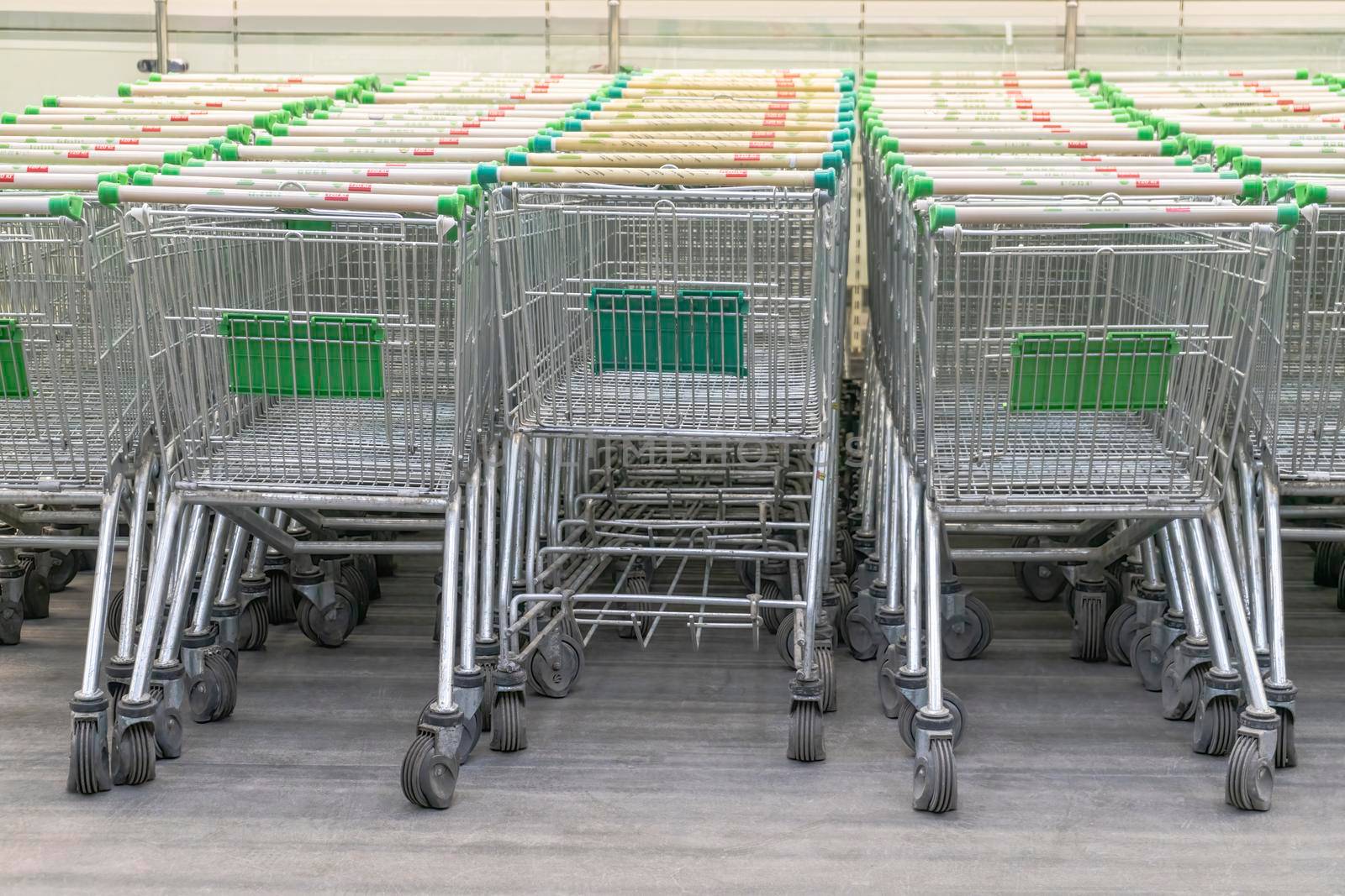 grocery carts in the shopping center parking lot by roman112007