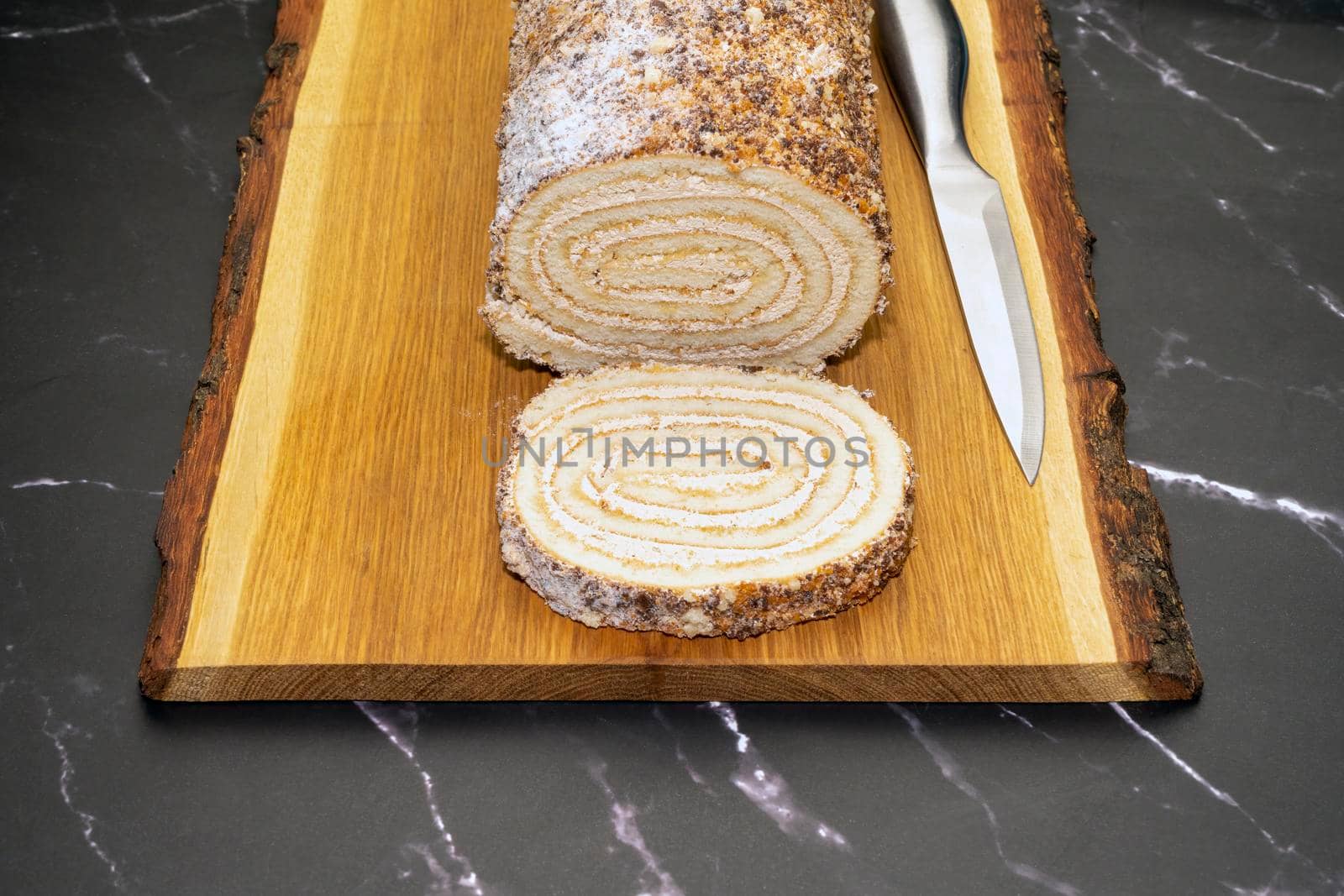 pastry roll on a wooden Board on black marble. High quality photo
