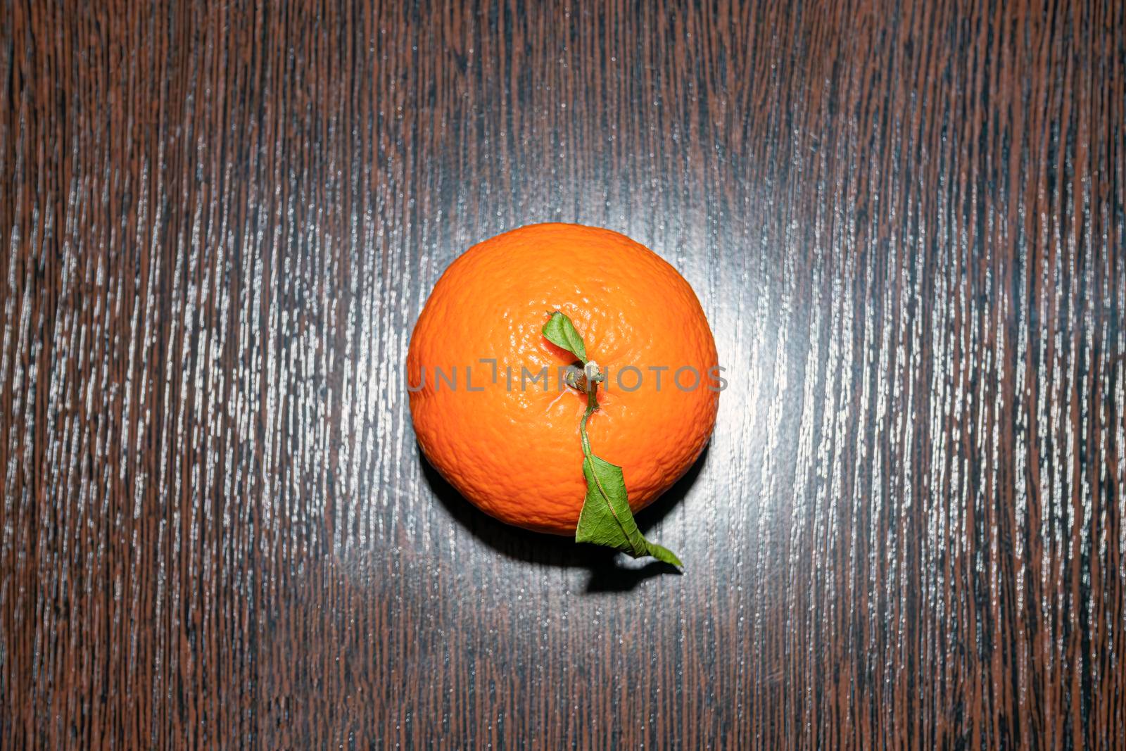 tangerine with leaves on a wooden table top view. High quality photo