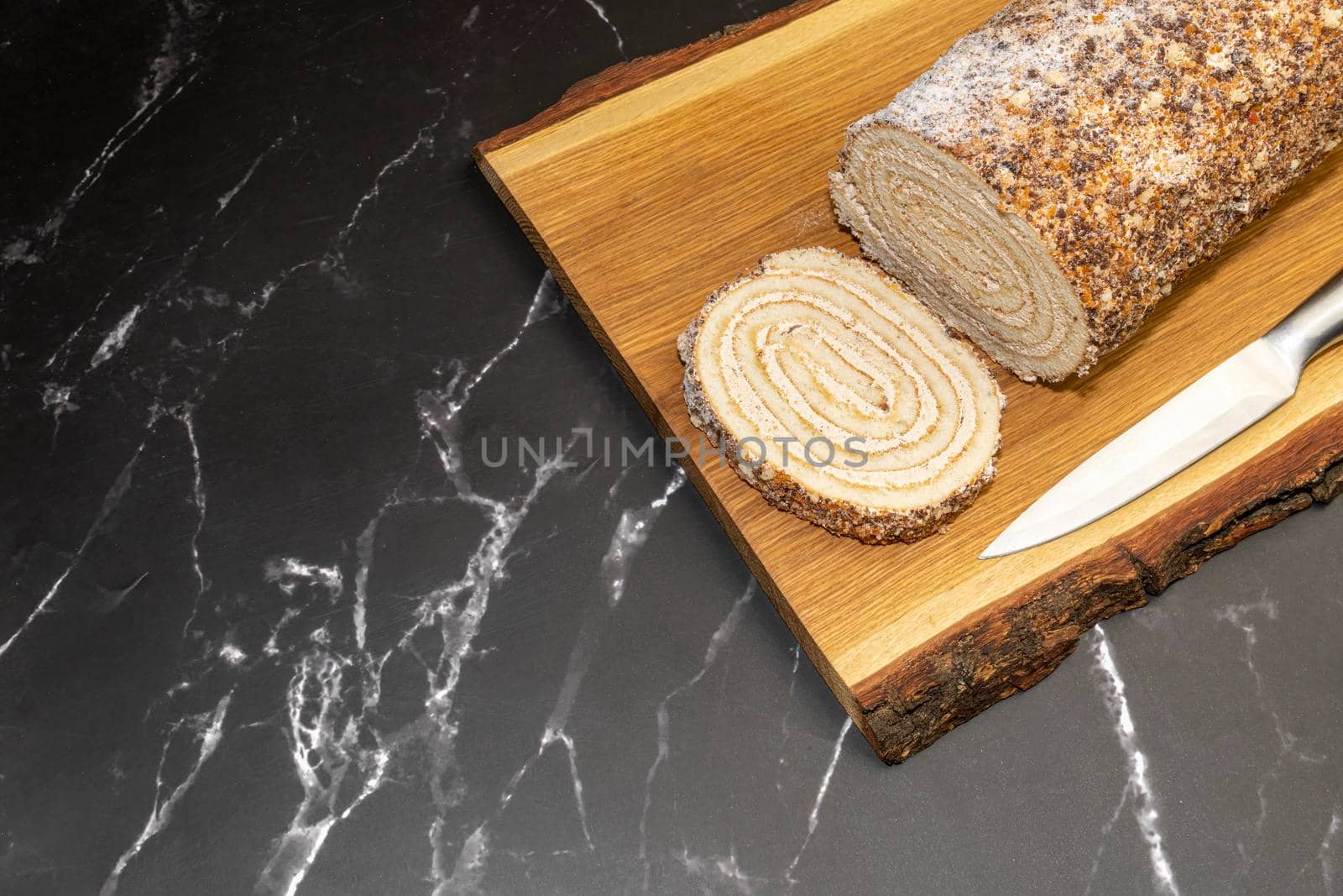 pastry roll on a wooden Board on black marble. High quality photo