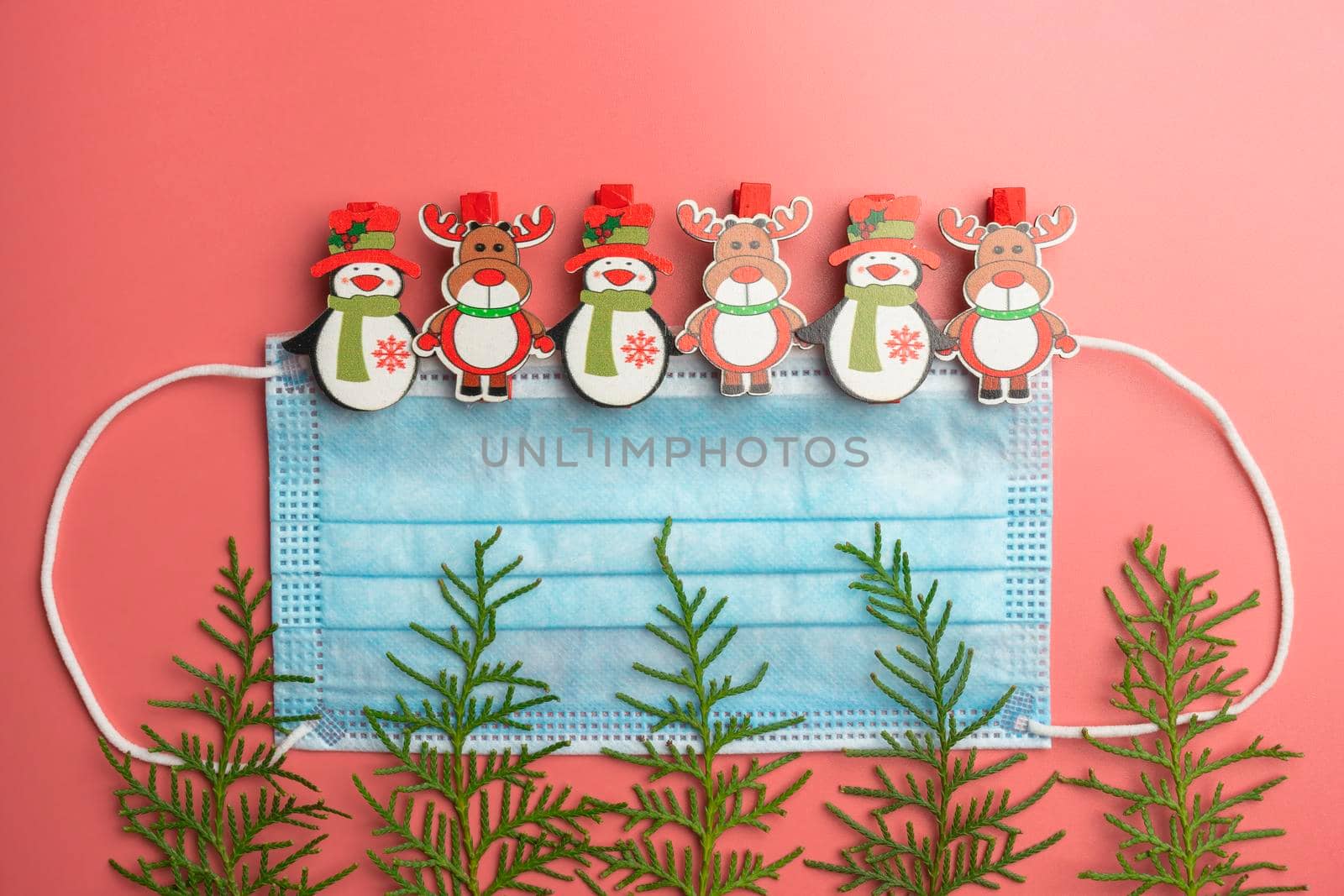 medical mask with Christmas toys and thuja branches. High quality photo