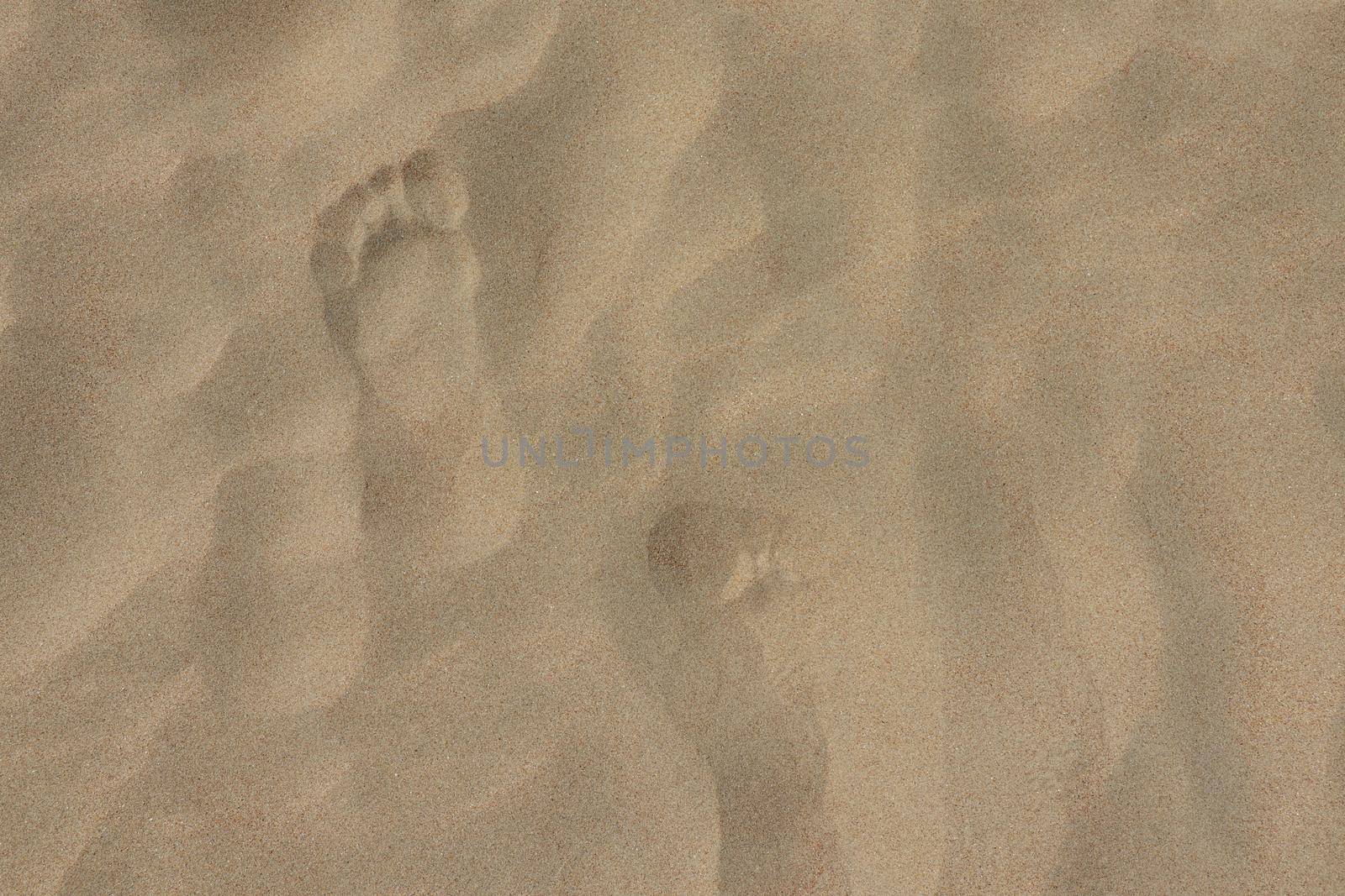 footprints on the beach dune sand as a background. High quality photo