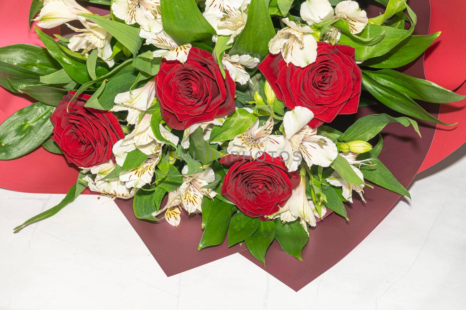 bouquet of red roses and white alstroemeria flowers close up. High quality photo