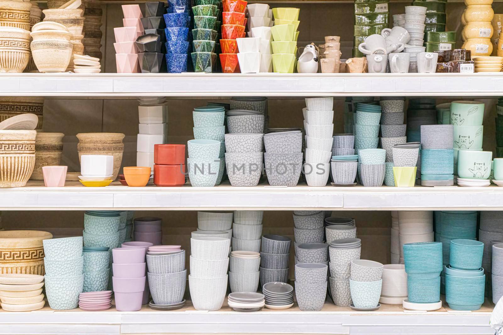 colorful flower pots on the shelves of the store . for the entire frame. High quality photo