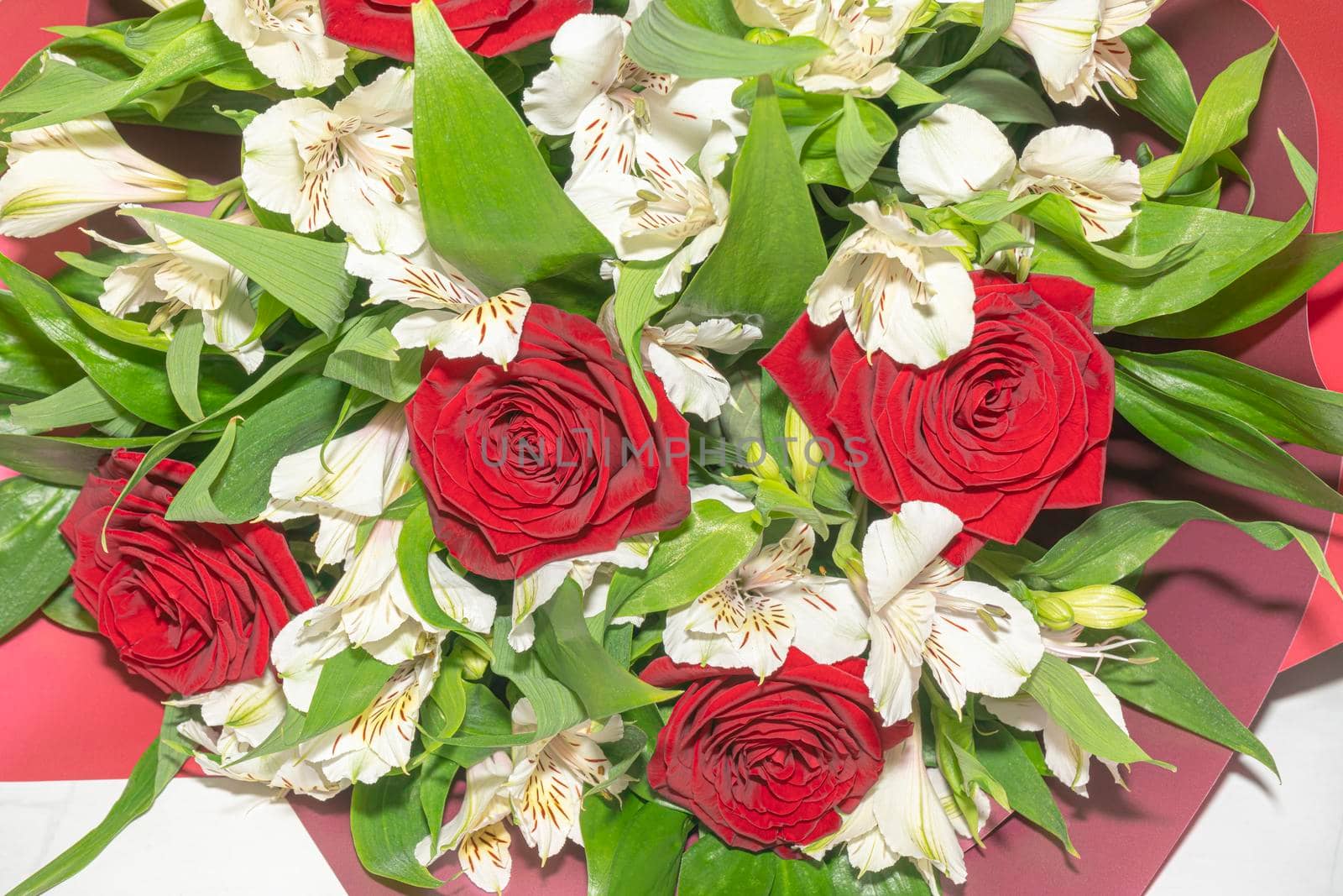 bouquet of red roses and white alstroemeria flowers close up. High quality photo