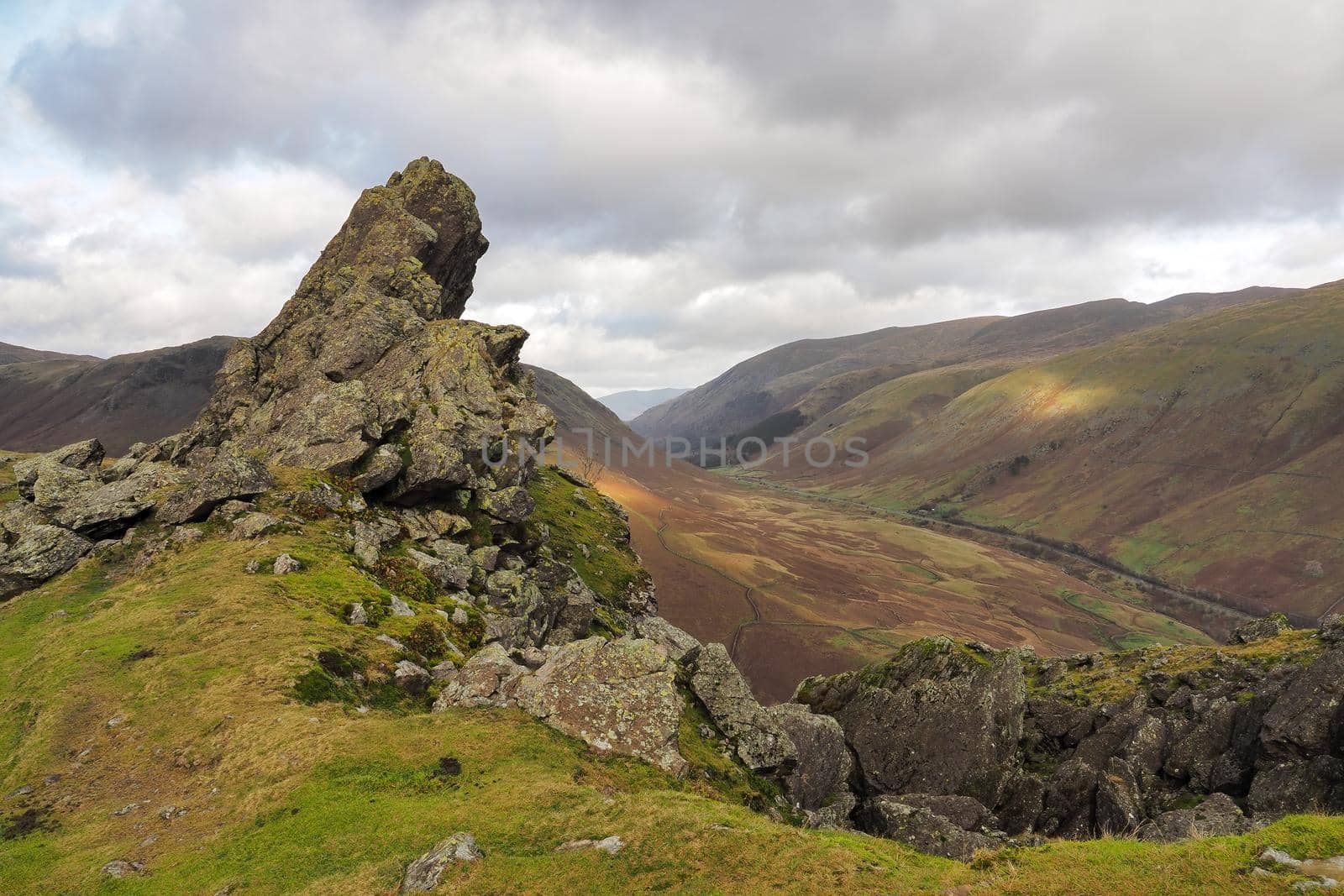 The rock formation known as 'The Howitzer' on Helm Crag overlooking the road through the valley, Lake District, UK