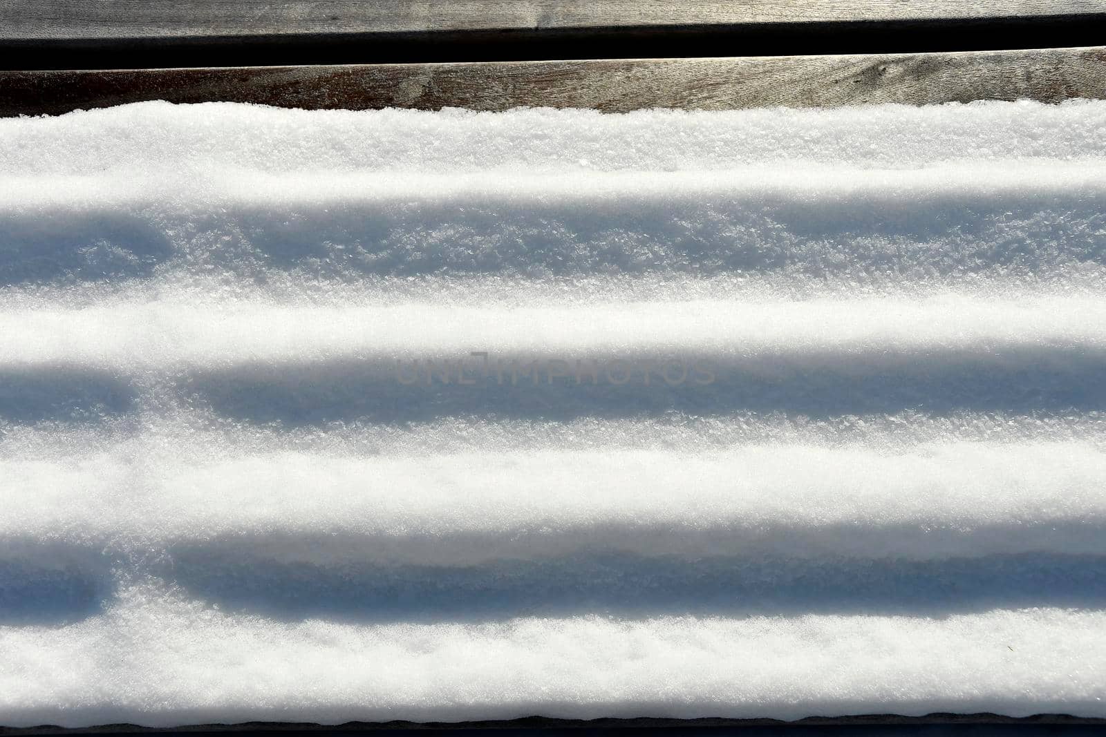 park bench with snow in Germany by Jochen