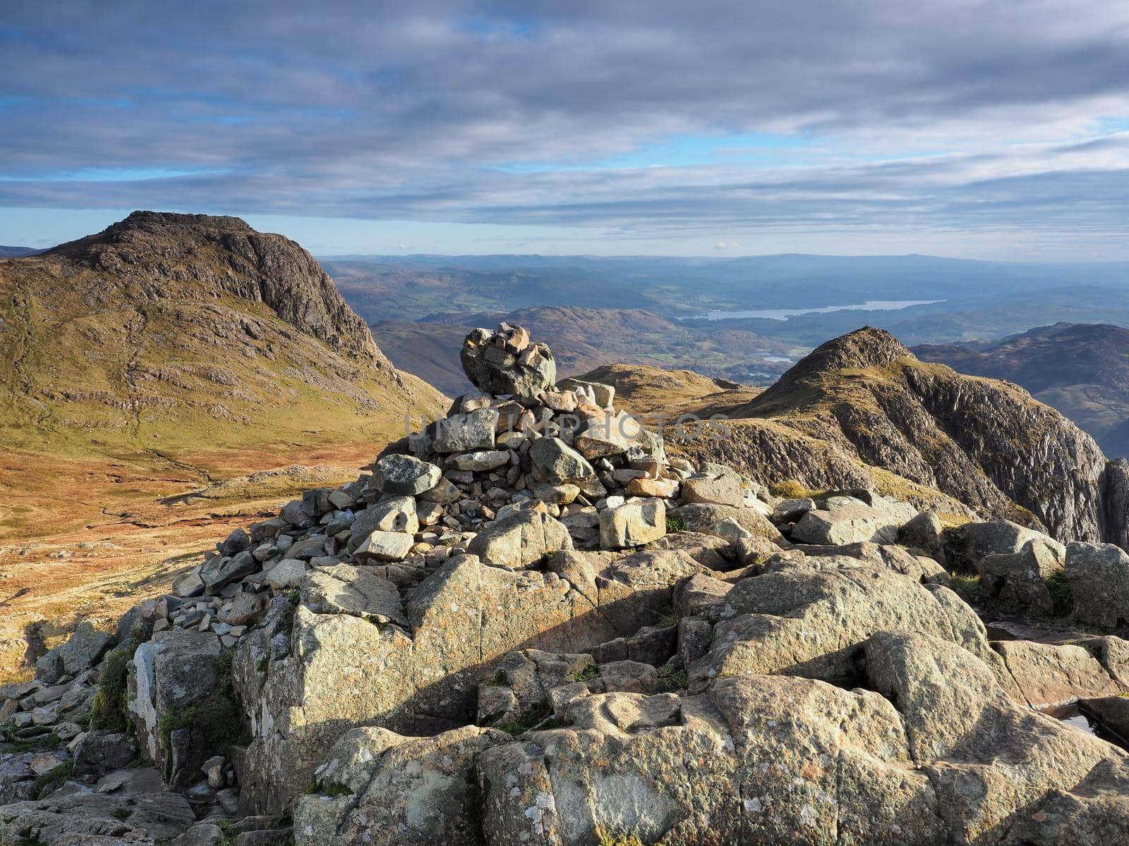View to Harrison Stickle from cairn on Pike of Stickle, overlooking Loft Crag with Windermere lake in the background, Langdale Pikes, Lake District, UK