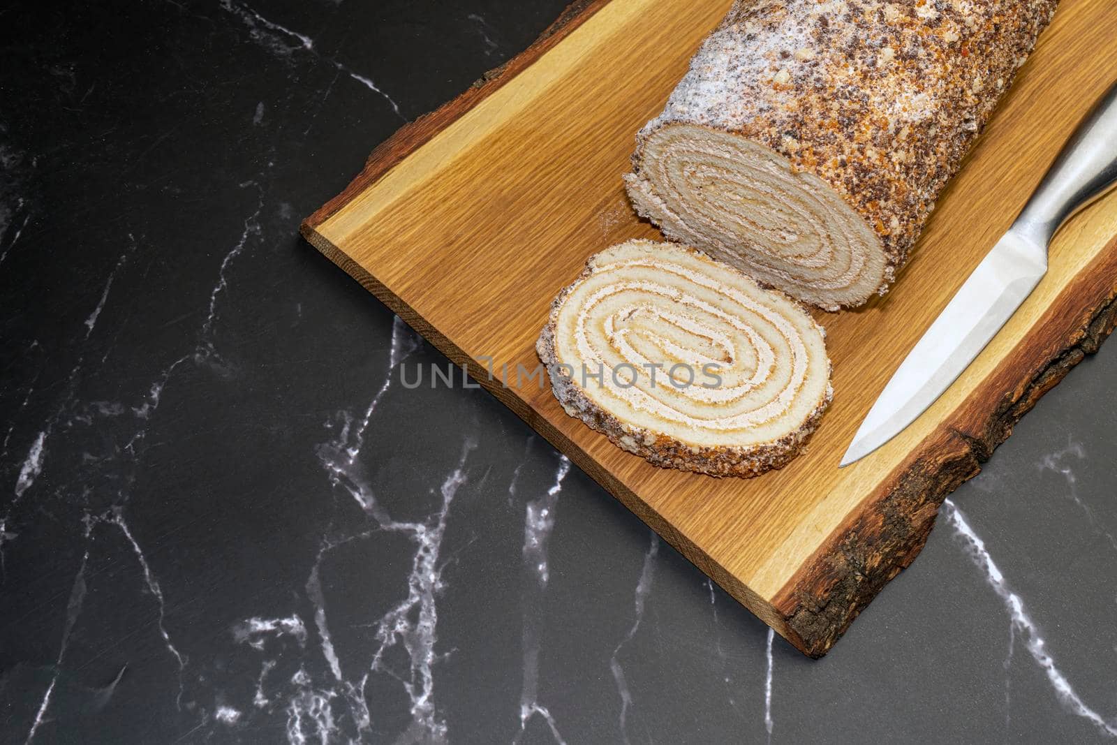 pastry roll on a wooden Board on black marble. High quality photo