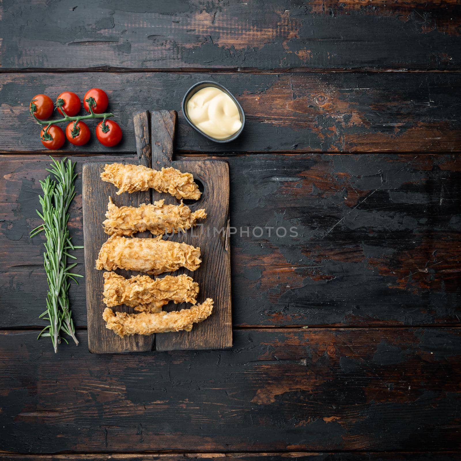 Chicken breaded breast on dark wooden background, flat lay, with space for text by Ilianesolenyi