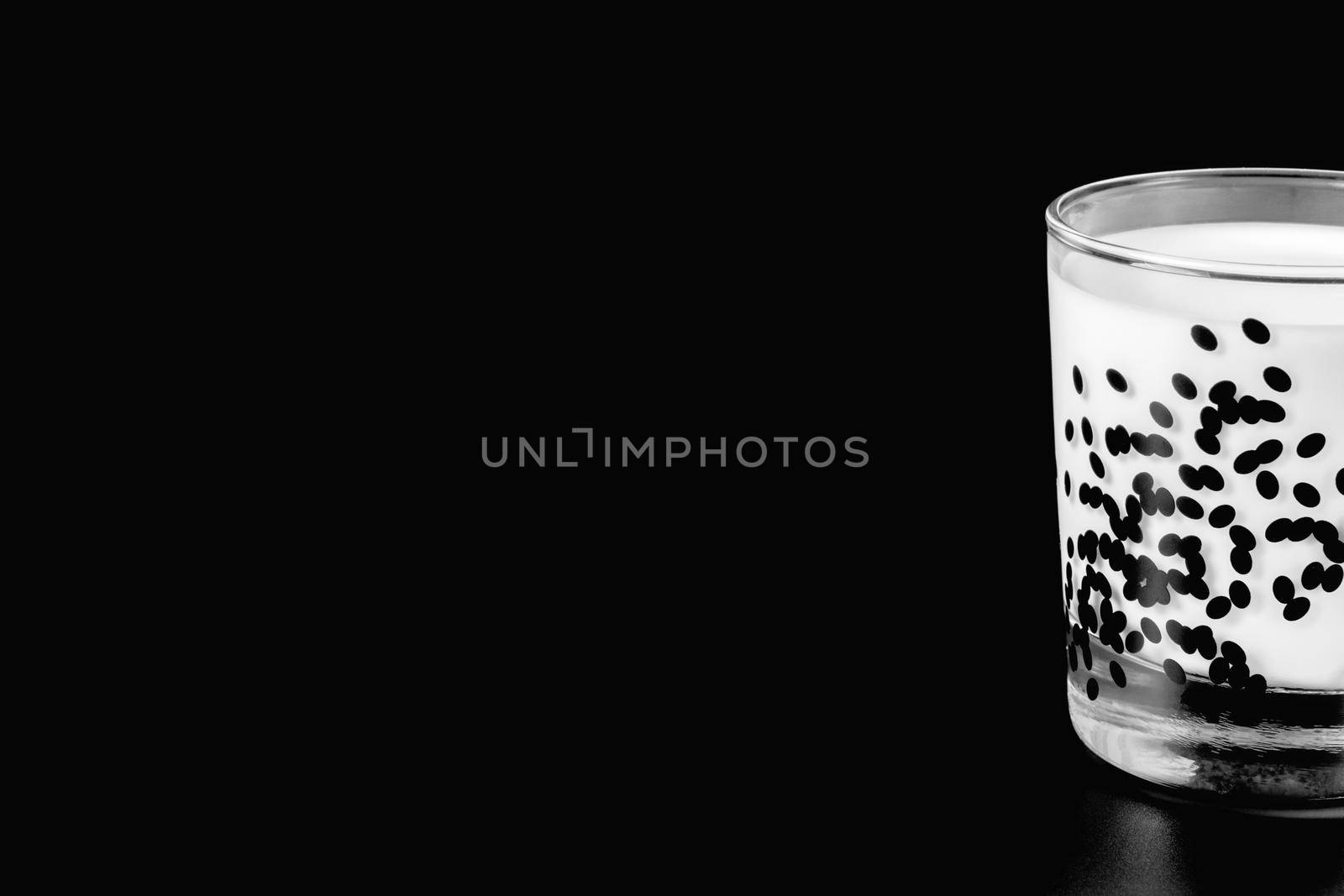 a glass of milk on a black background. health food. isolate by roman112007