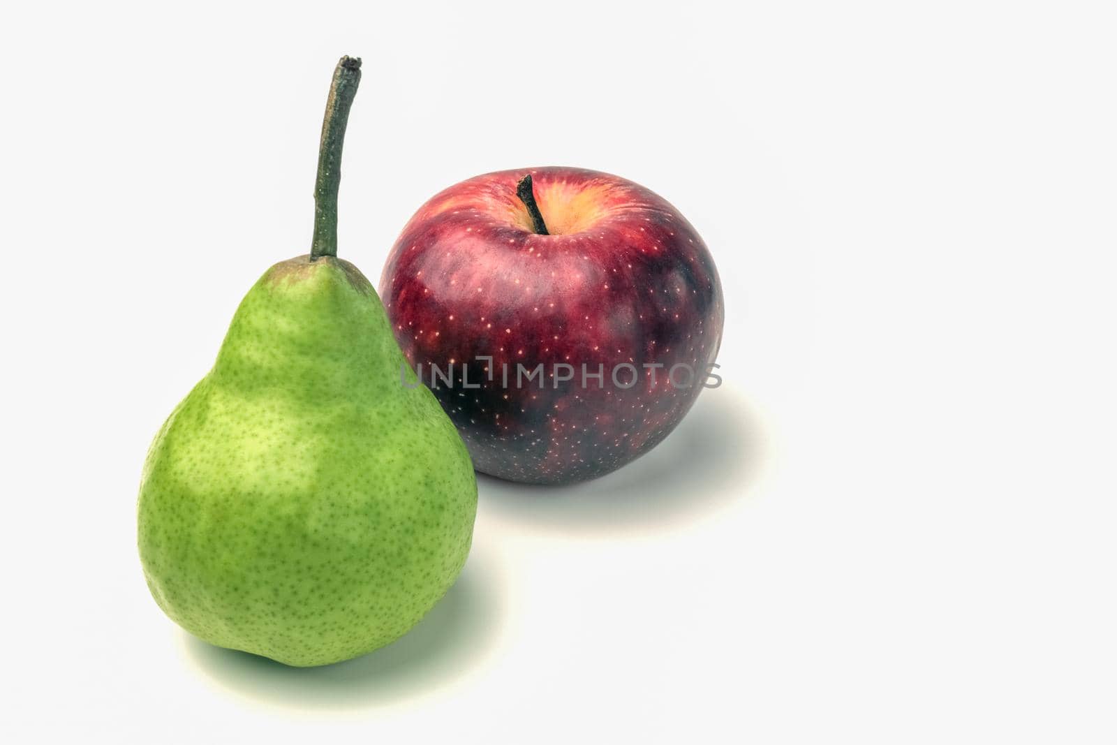 green pear and red Apple close up on white background. High quality photo