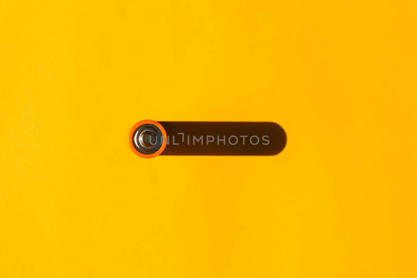 battery with a hard shadow on a plain background. the view from the top. blank for the pattern. High quality photo