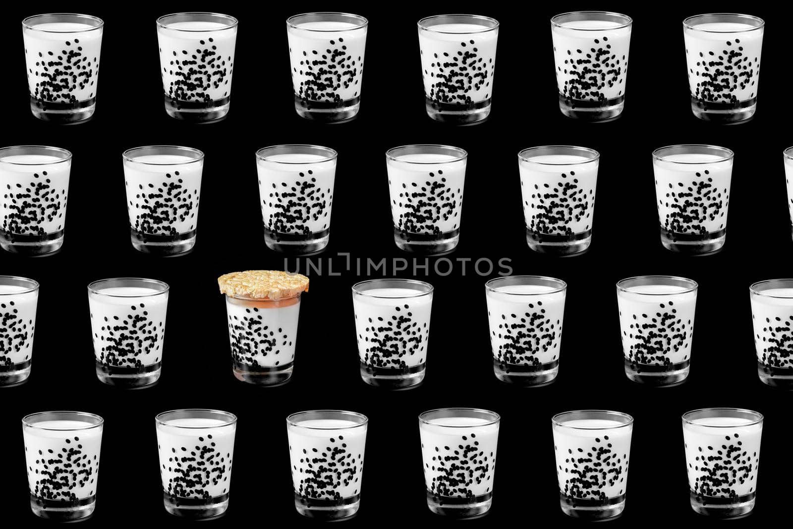 colorful pattern of a glass of milk on a black background top view. High quality photo