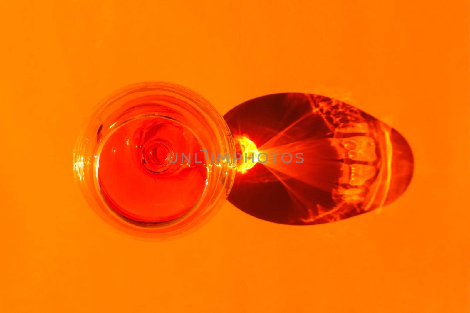 a glass with a hard shadow on a plain background. the view from the top. blank for the pattern. High quality photo
