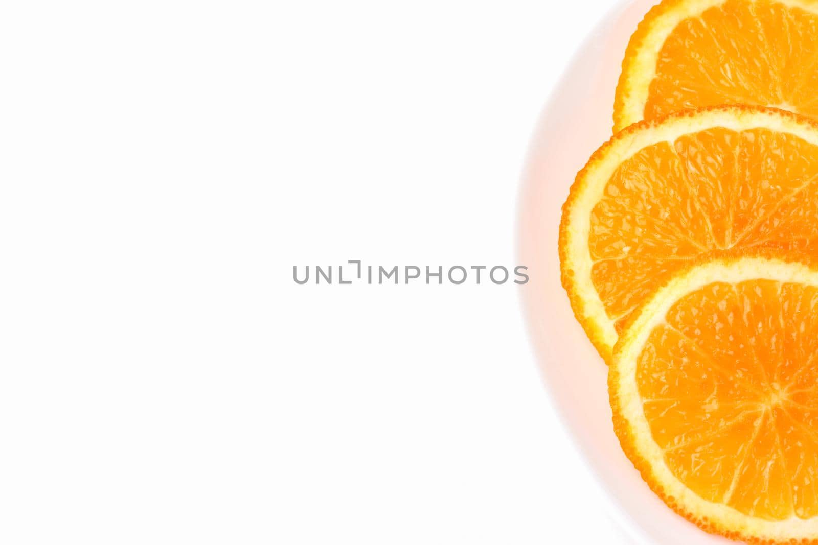 orange slices on a white plate on a white background. High quality photo