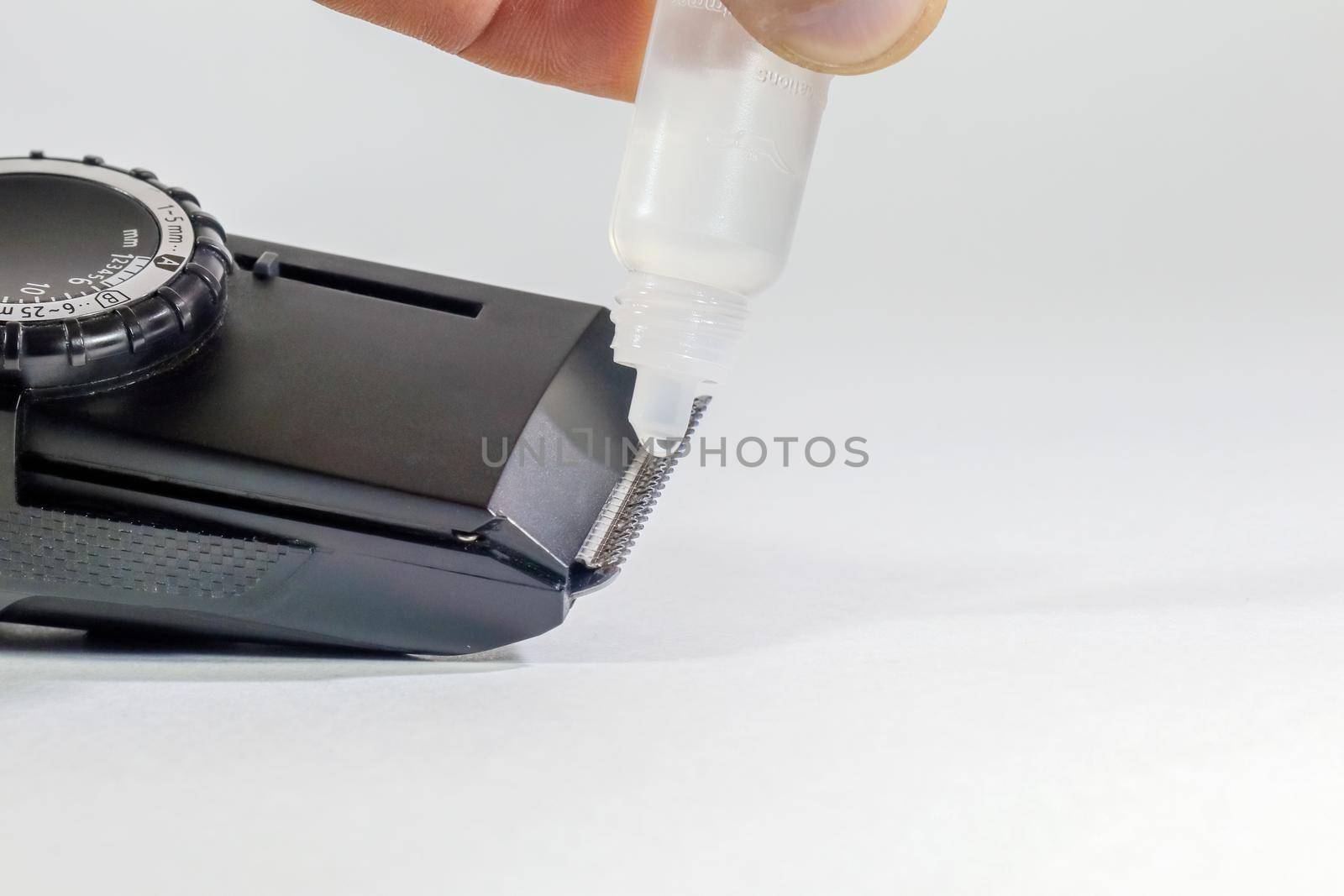 grooming a clipper on a white background macro by roman112007