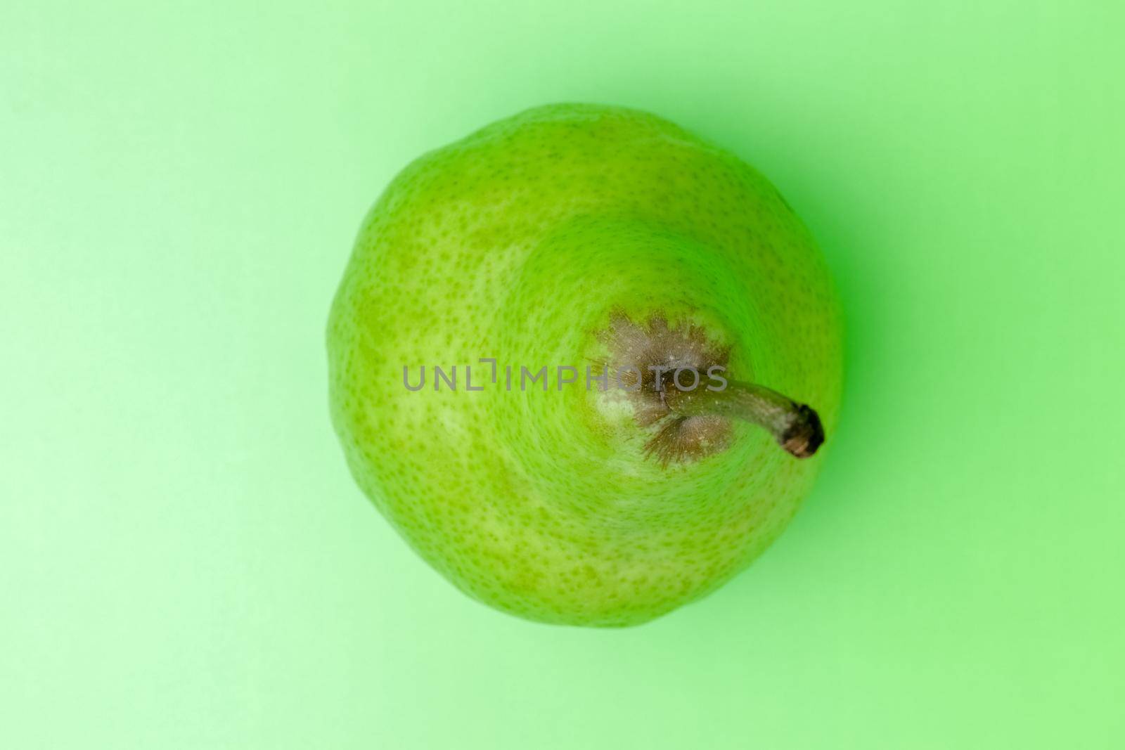 pear on a green background close-up. place for inscription by roman112007