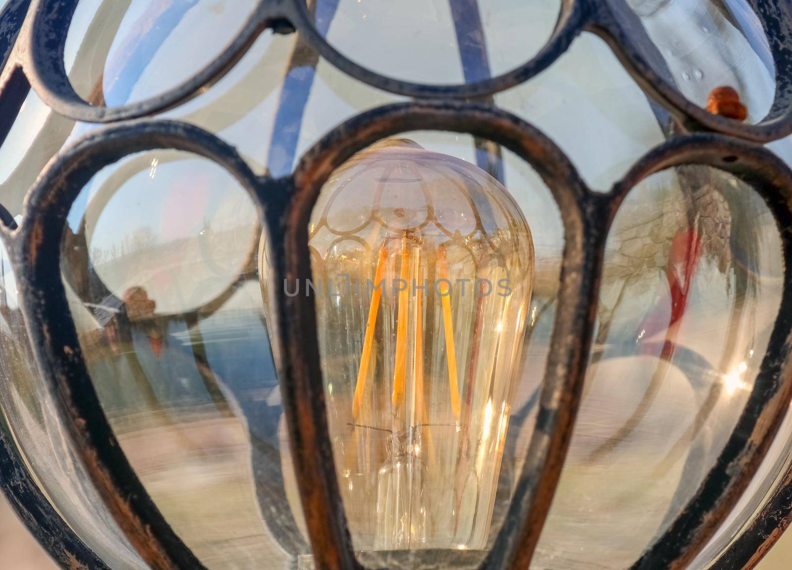 lamp with incandescent lamp close up as background. High quality photo