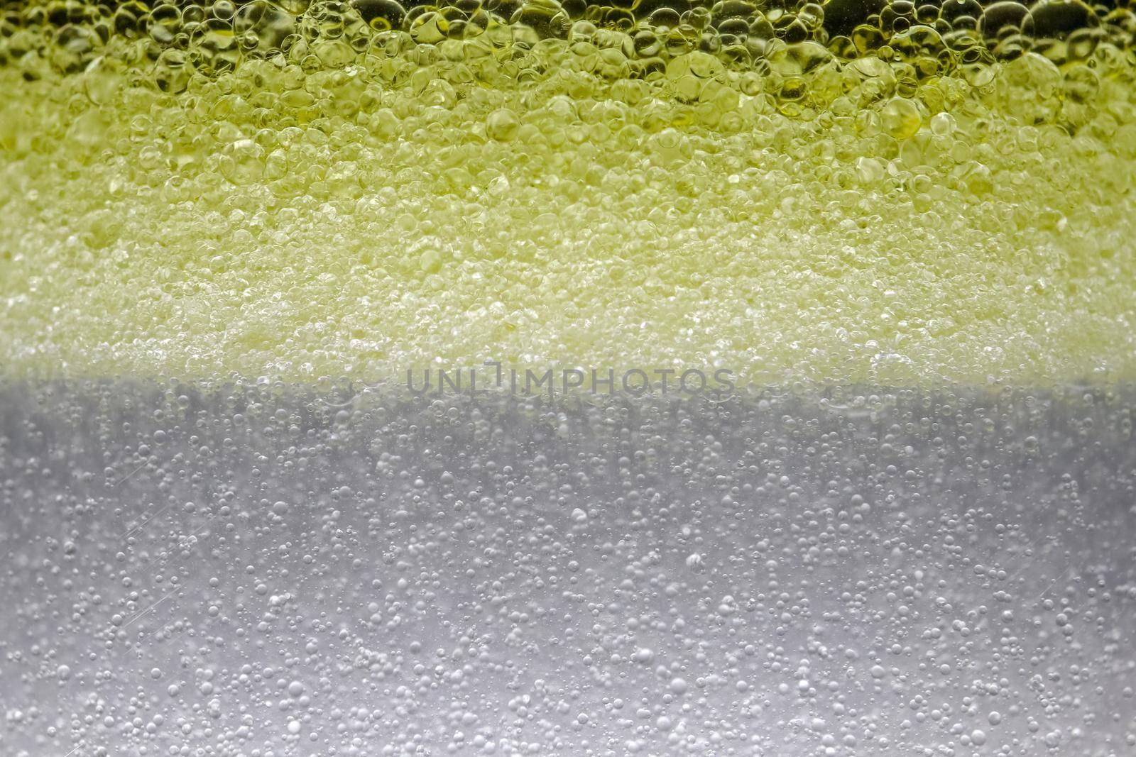 bubbles in yellow micellar water as background. High quality photo