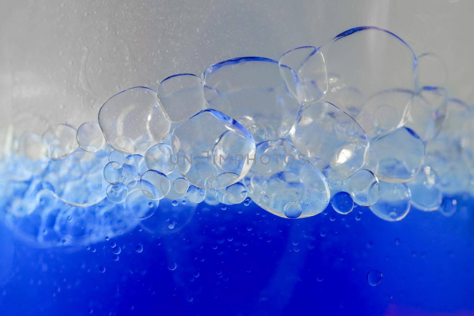 blue bubbles of micellar water macro as background. high-quality photos