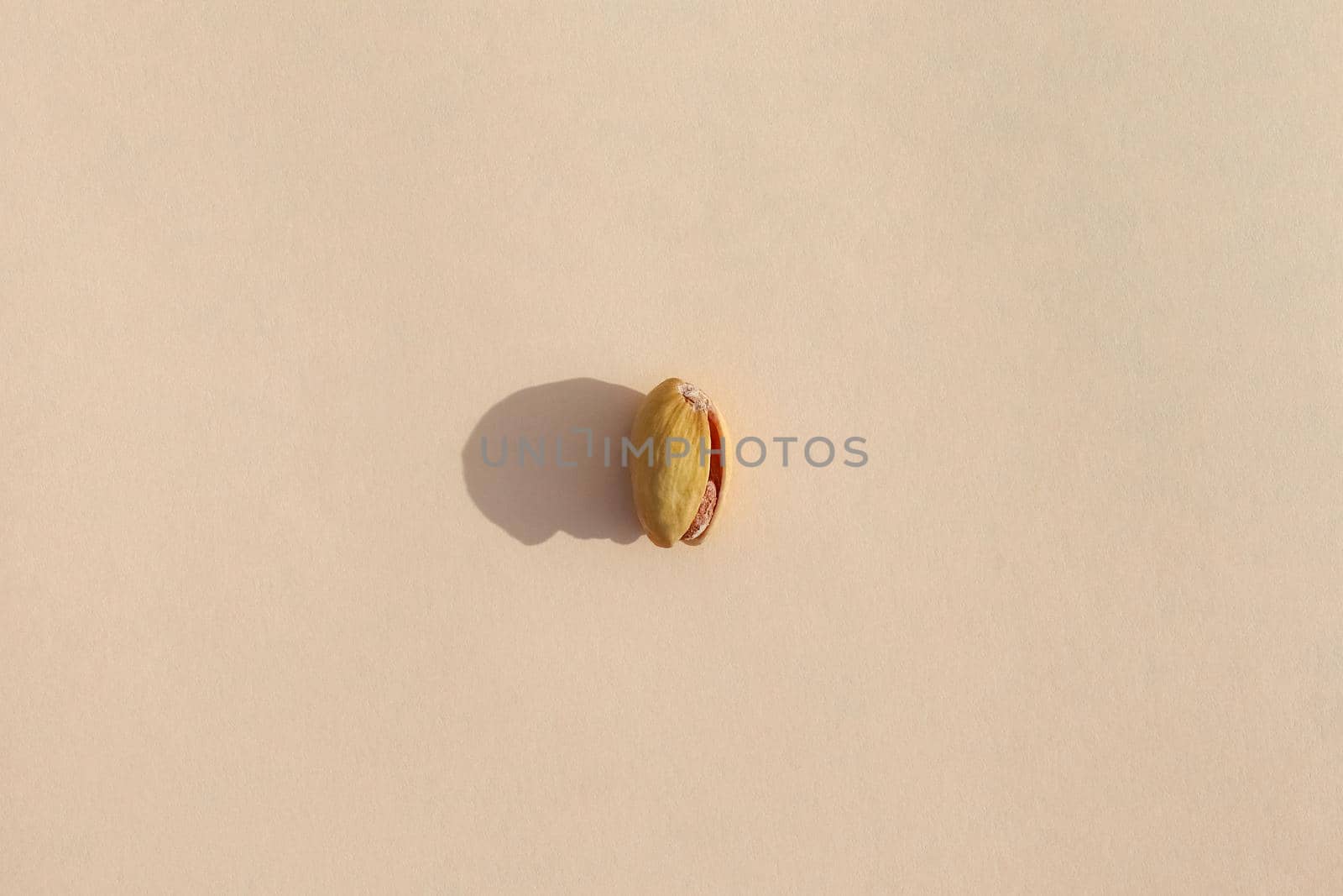 pistachio with a hard shadow on a colored background pattern. High quality photo