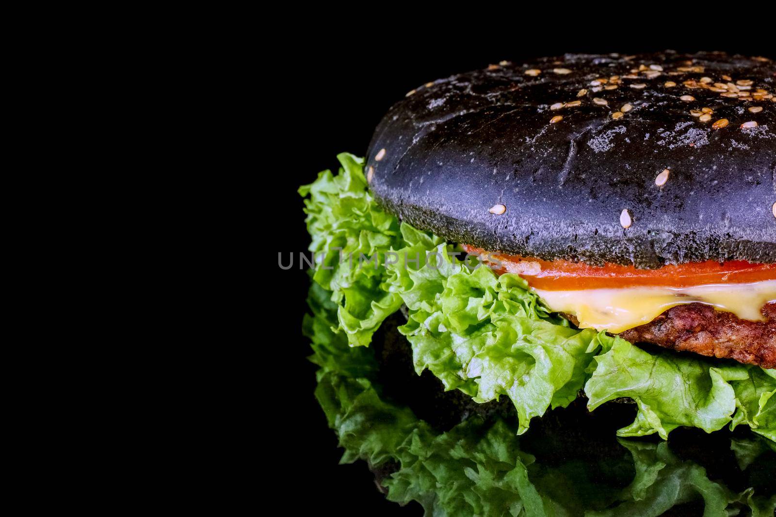 black hamburger close up on a black background macro isolate