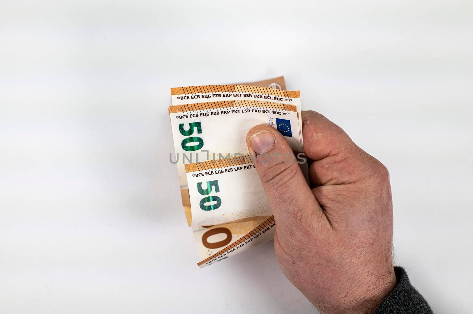 man hand counting 50 euro bills on white background