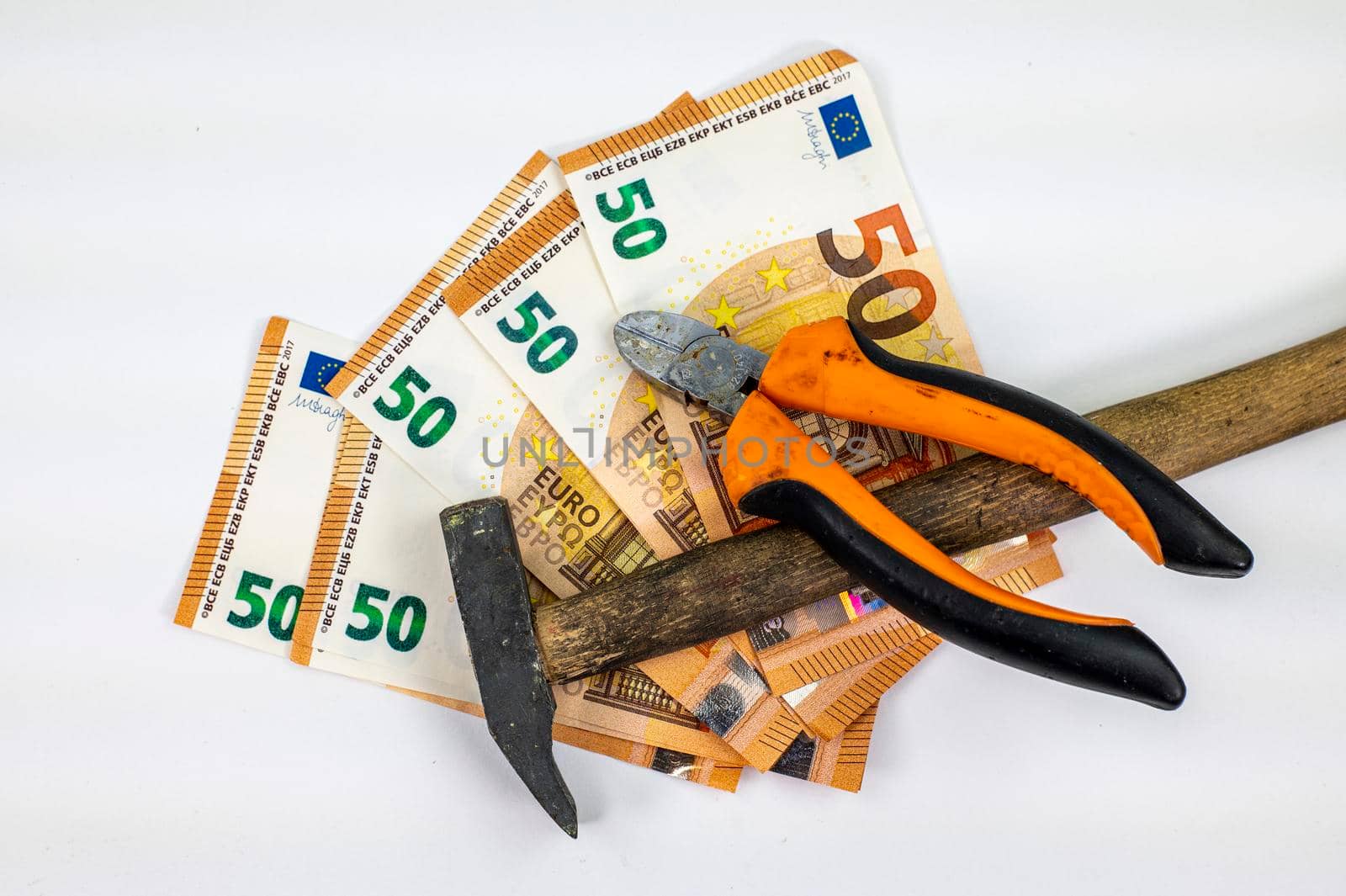 50 euro bills with work tools on white background