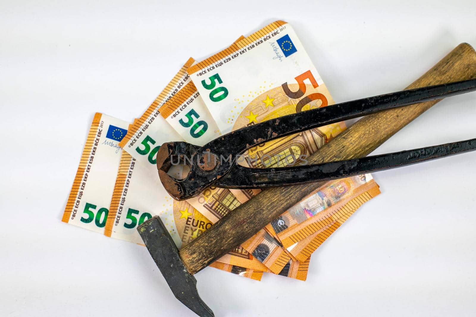 50 euro bills with work tools on white background