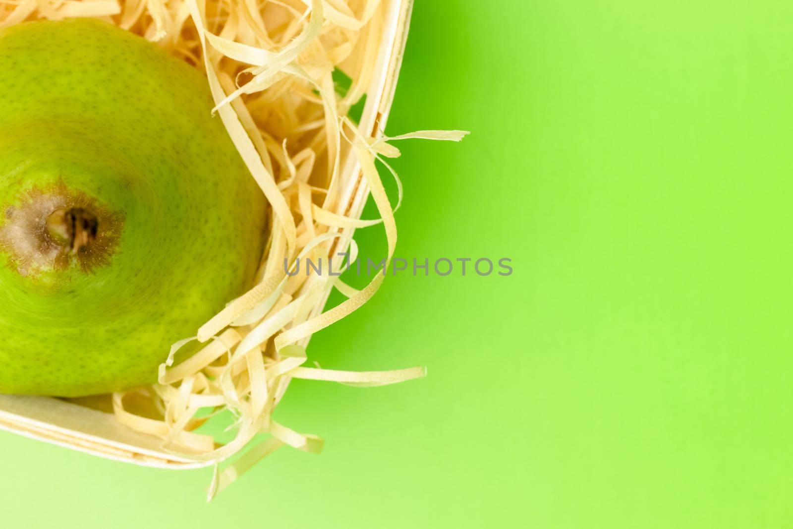 pear basket on a green background close-up. High quality photo