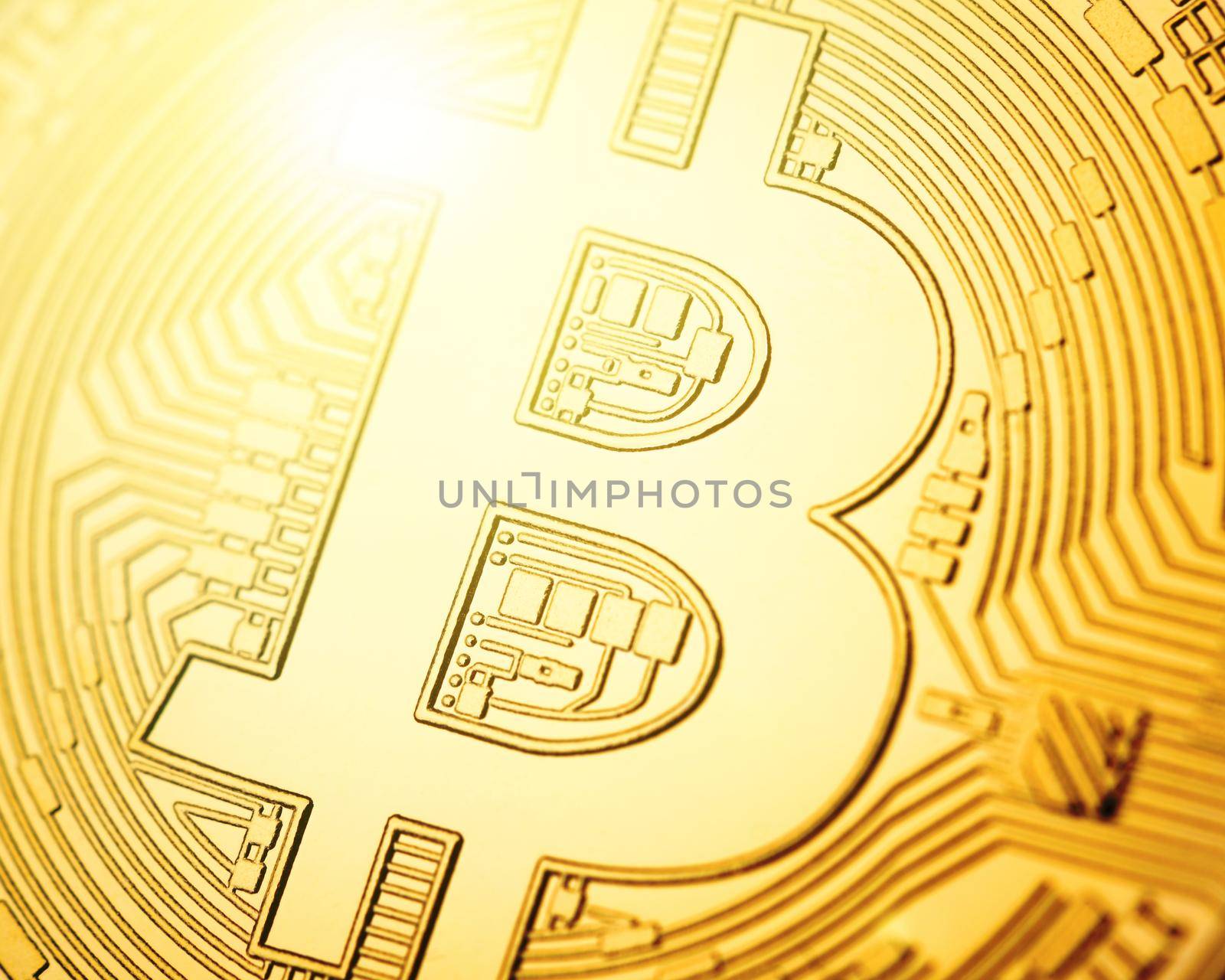 Macro shot of physical cryptocurrency Bitcoin, golden coin with lens flare