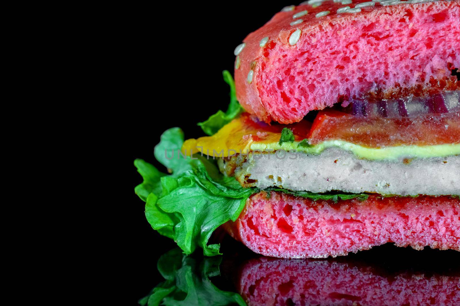 red hamburger on a black background macro isolate