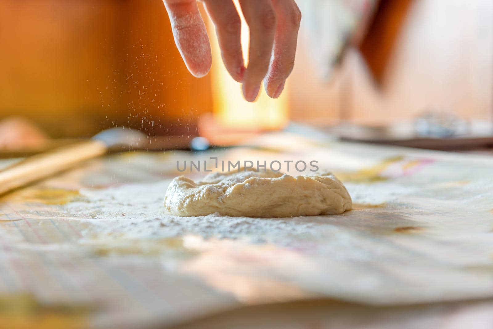woman baker prepares the dough on table