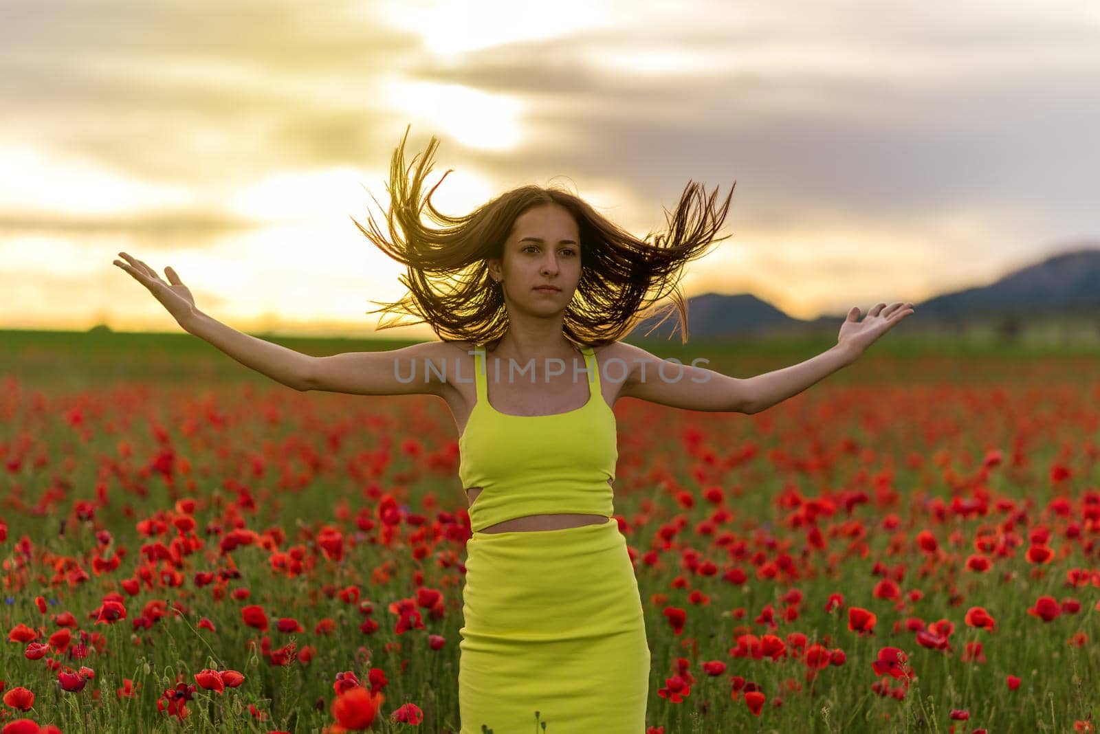 beautiful girl in a poppy field at sunset by ba11istic