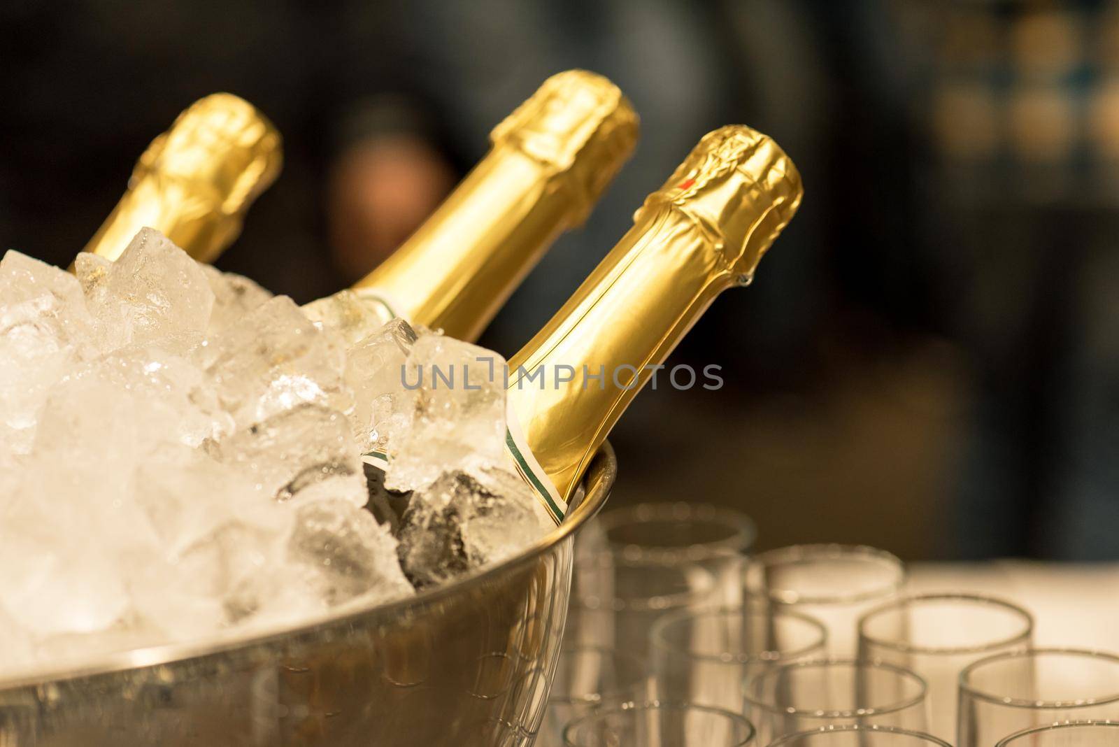 Bottle of champagne in bucket of ice.