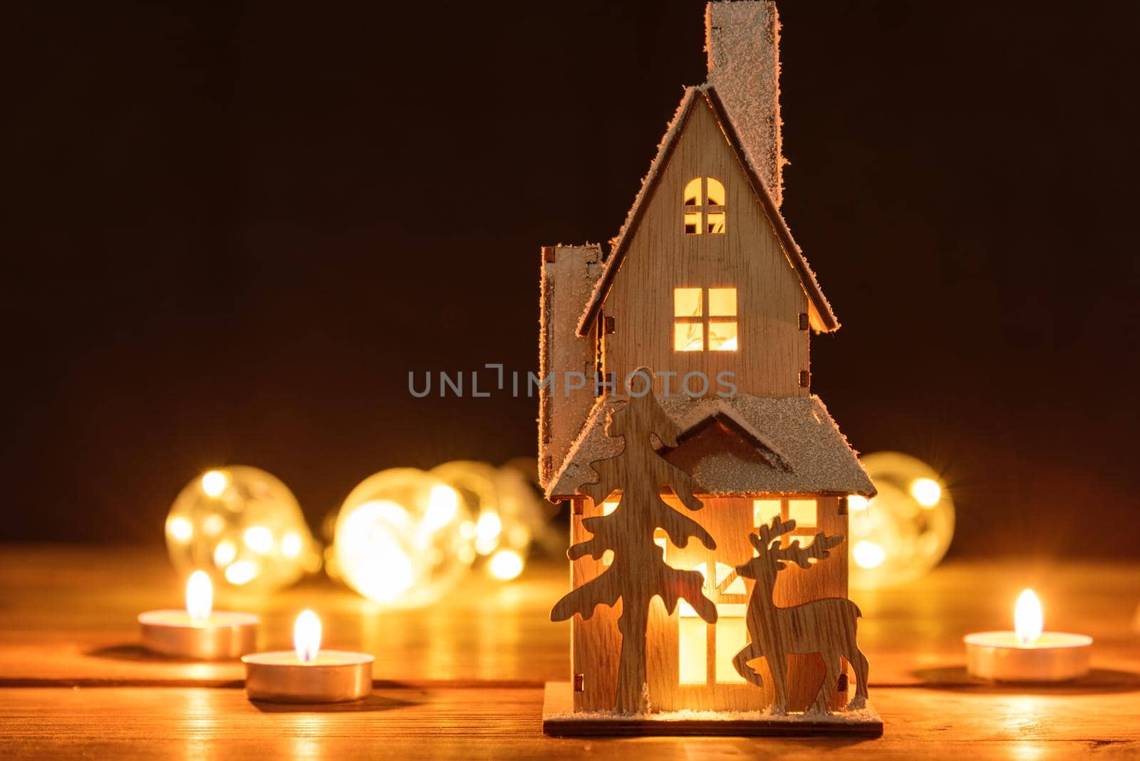 Christmas house decoration on defocused lights background.