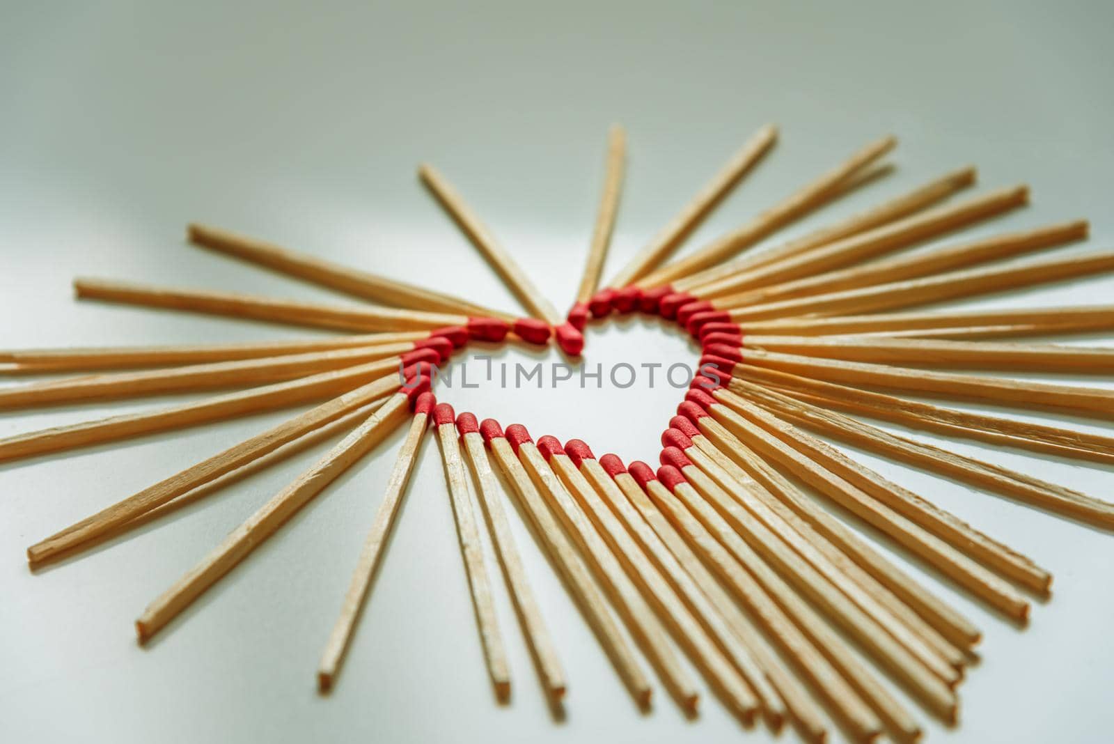 closeup of matchsticks arranged to form a heart shape with depth of field