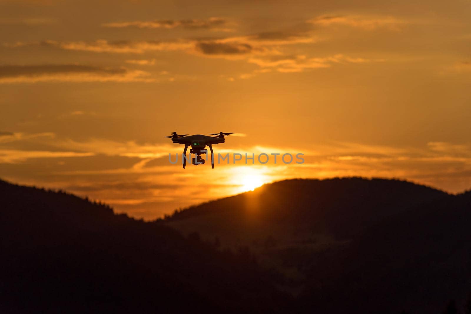 drone quad copter with digital camera at sunset ready to fly for surveillance