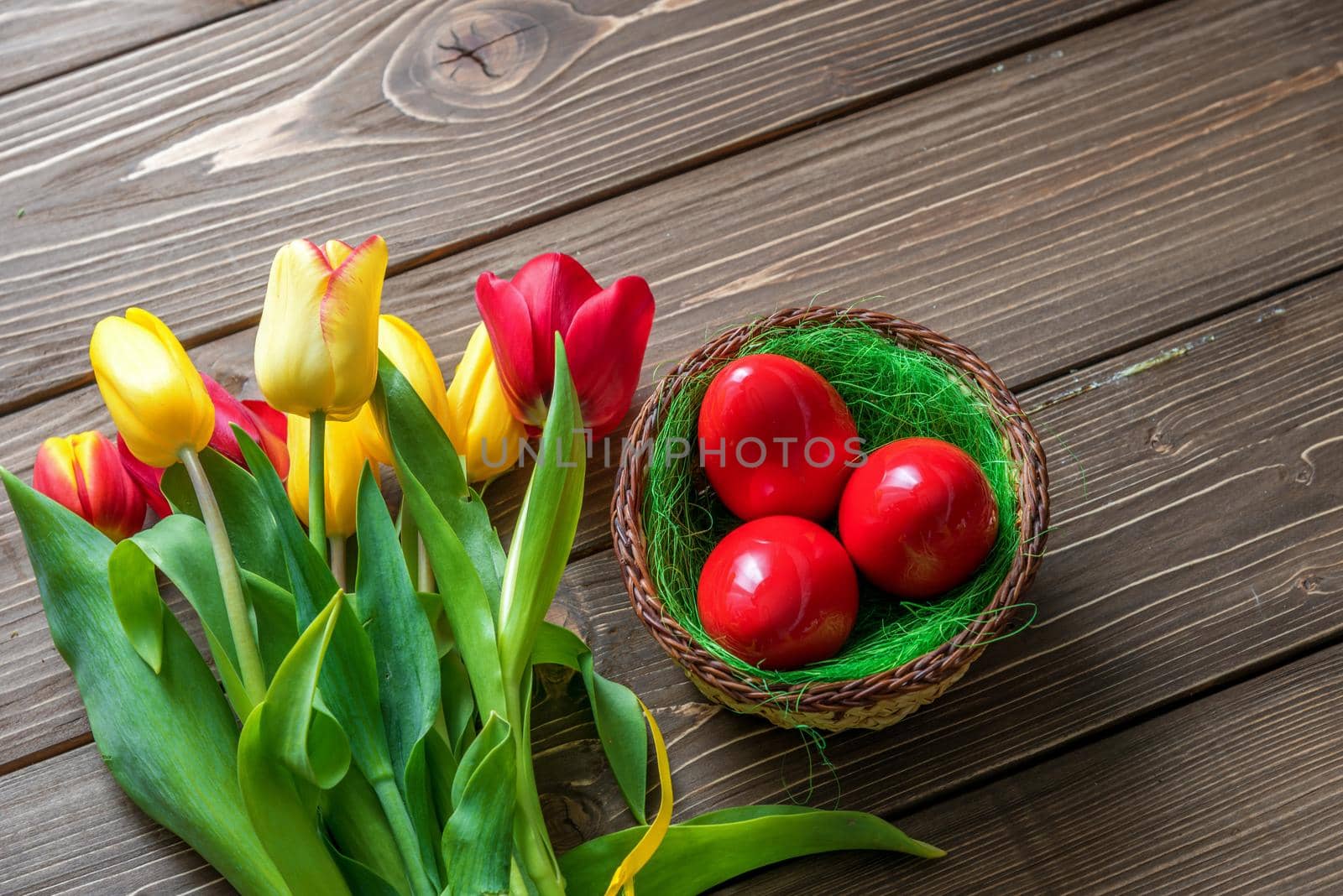 Tulips and easter eggs on vintage wooden