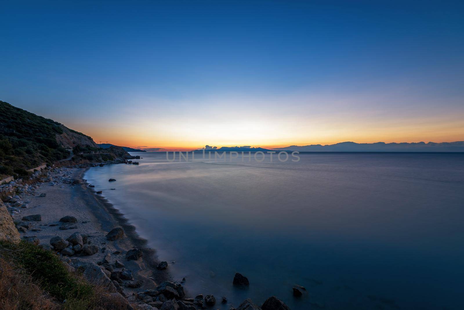 Sunrise over the sea, the rolling calm waves.