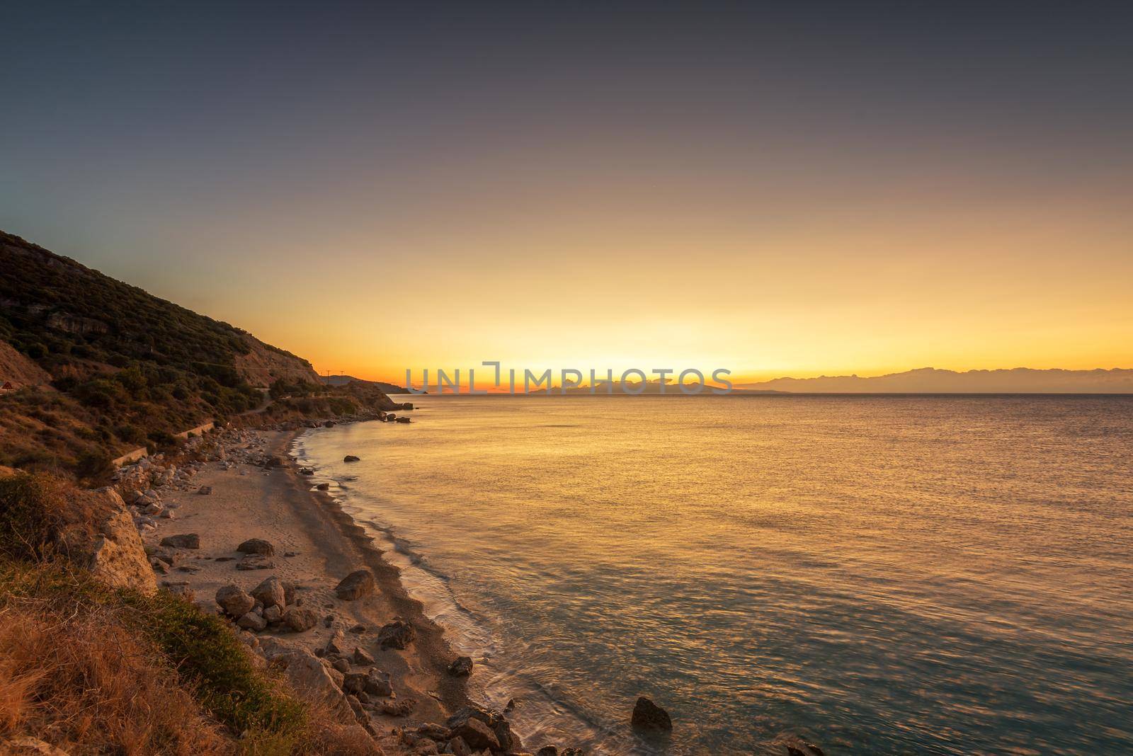 Sunrise over the sea, the rolling calm waves.