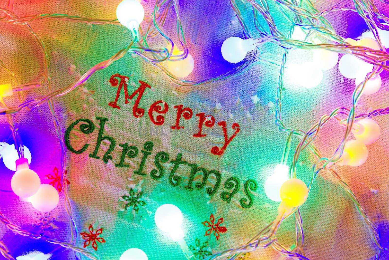 Merry Christmas Greeting with Glowing Colorful Christmas Lights