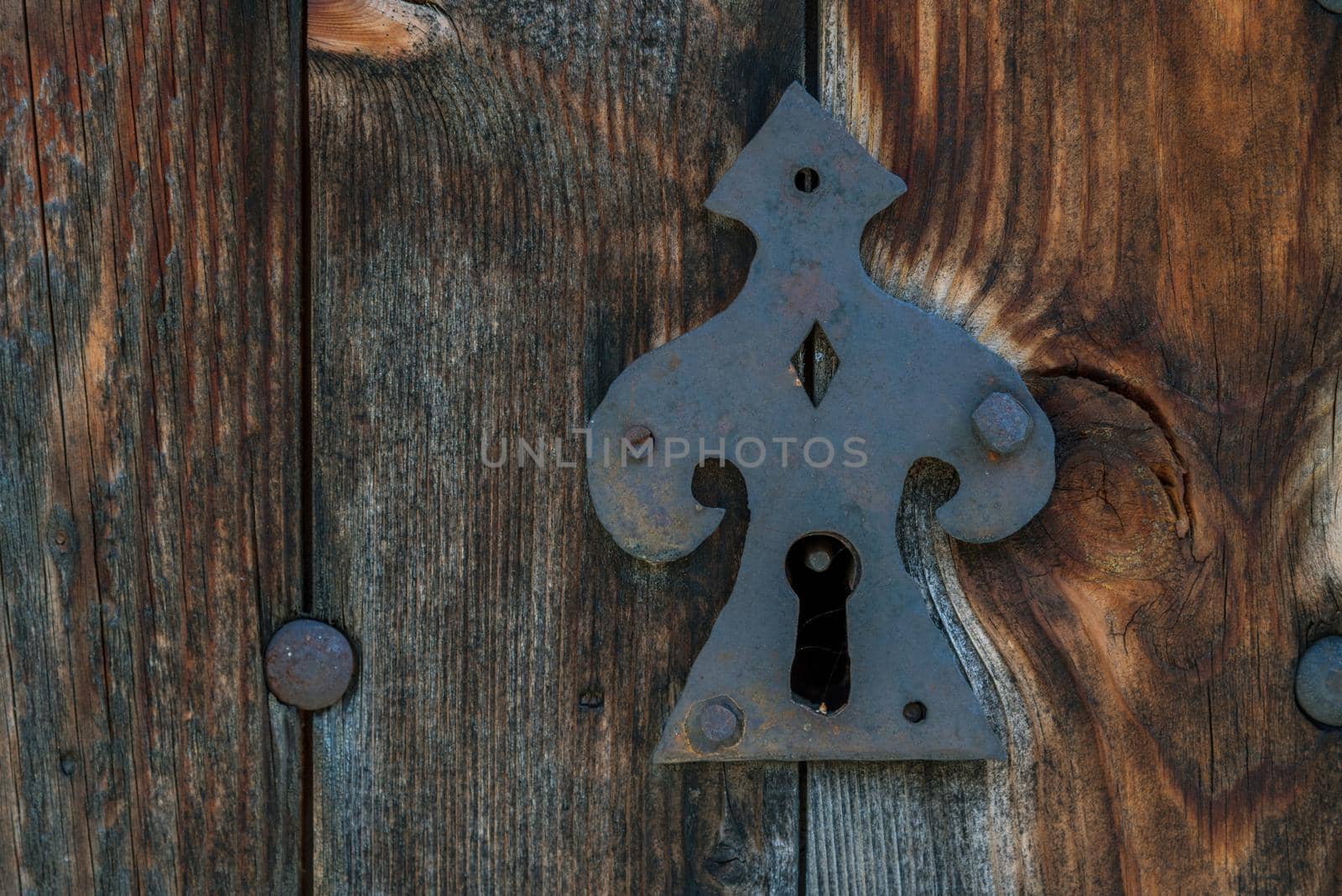 Old rusty metal lock and keyhole on a old turquoise wooden door as a vintage background