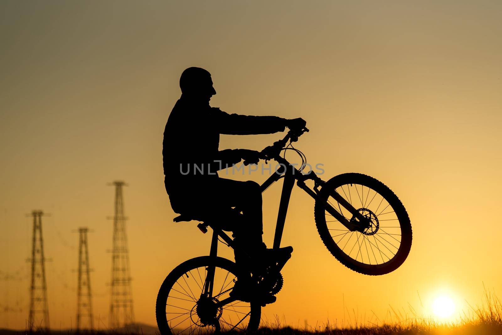 Silhouette of cycling on sunset background at sunset 