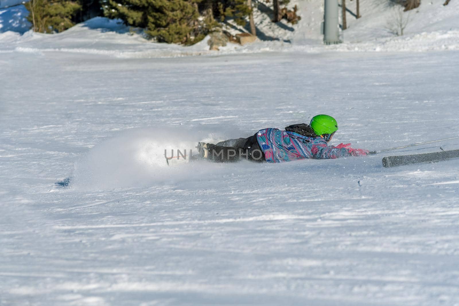 boy skier falling obliquely in winter days