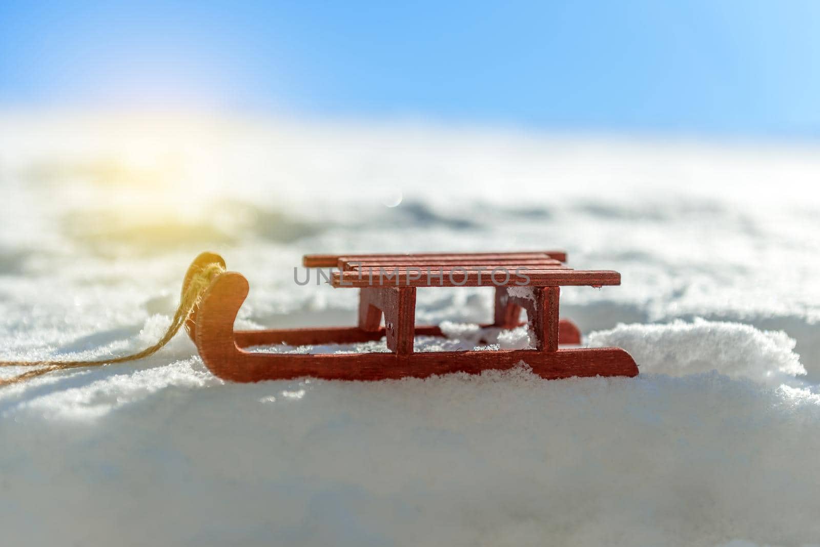 small red sled in the snow in beautiful winter day